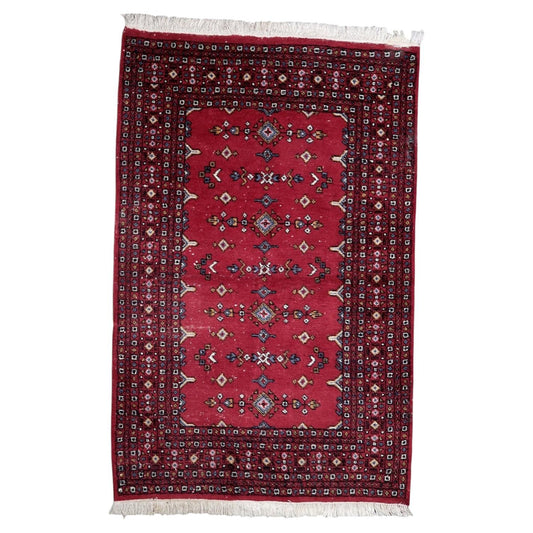 Vintage 1950s Uzbek Bukhara wool rug with rich red field and symmetrical diamond and arrow motifs in blue ivory and gold, 4.2 x 6.4 feet