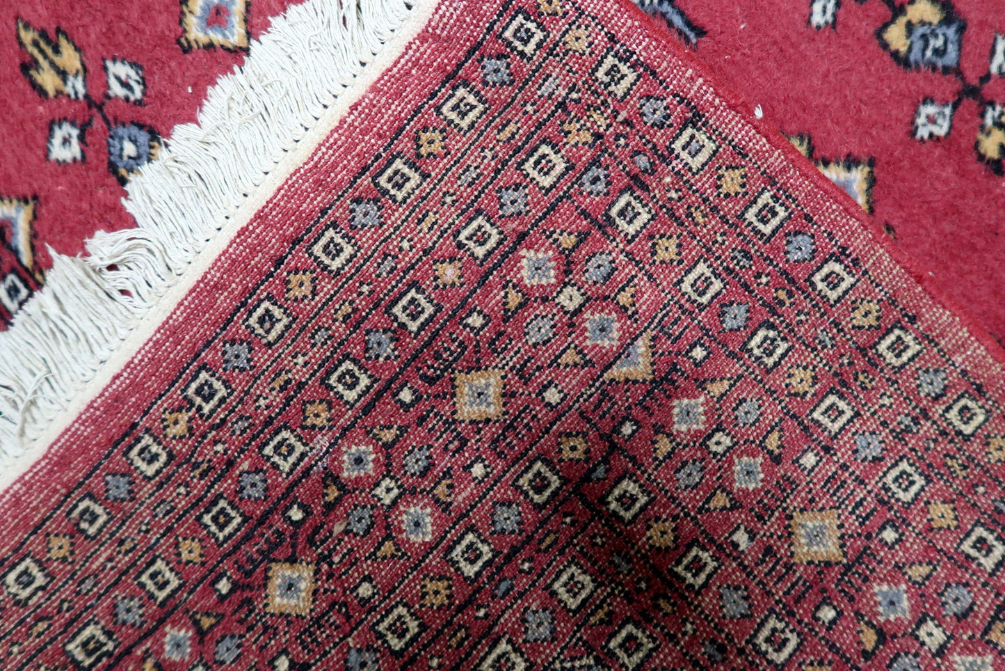 1950s hand-knotted Bukhara rug suitable as statement piece layered in contemporary interior