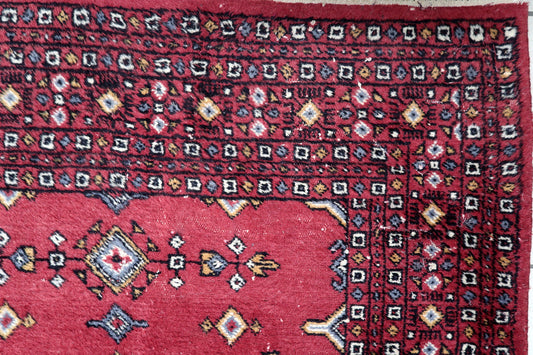 Close-up of geometric precision showing deep blue, ivory and golden accents on traditional Bukhara diamond patterns