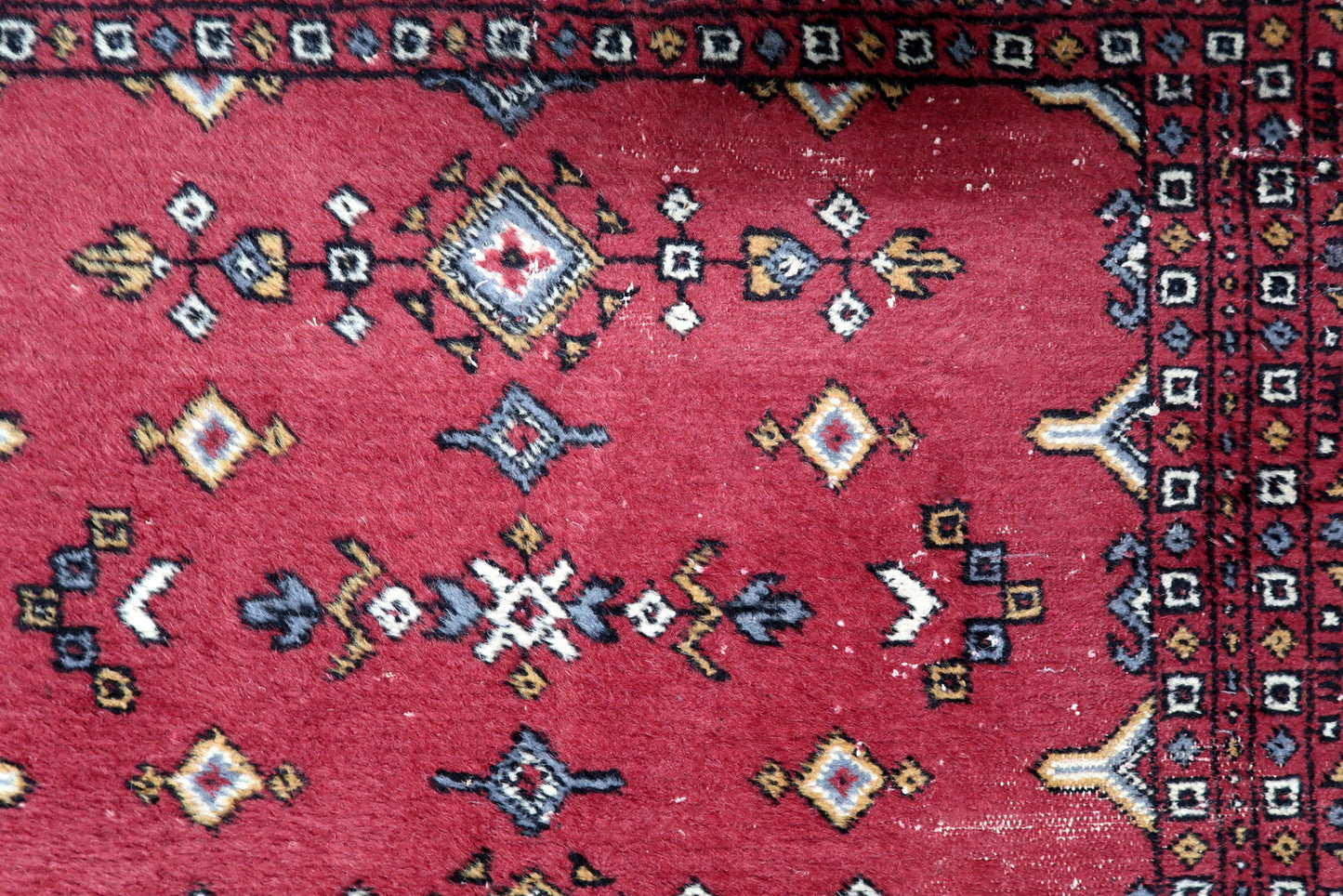 Detailed border showing small repeating geometric and floral-inspired elements characteristic of Uzbek weaving