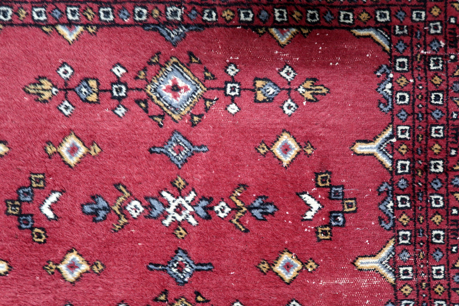 Detailed border showing small repeating geometric and floral-inspired elements characteristic of Uzbek weaving