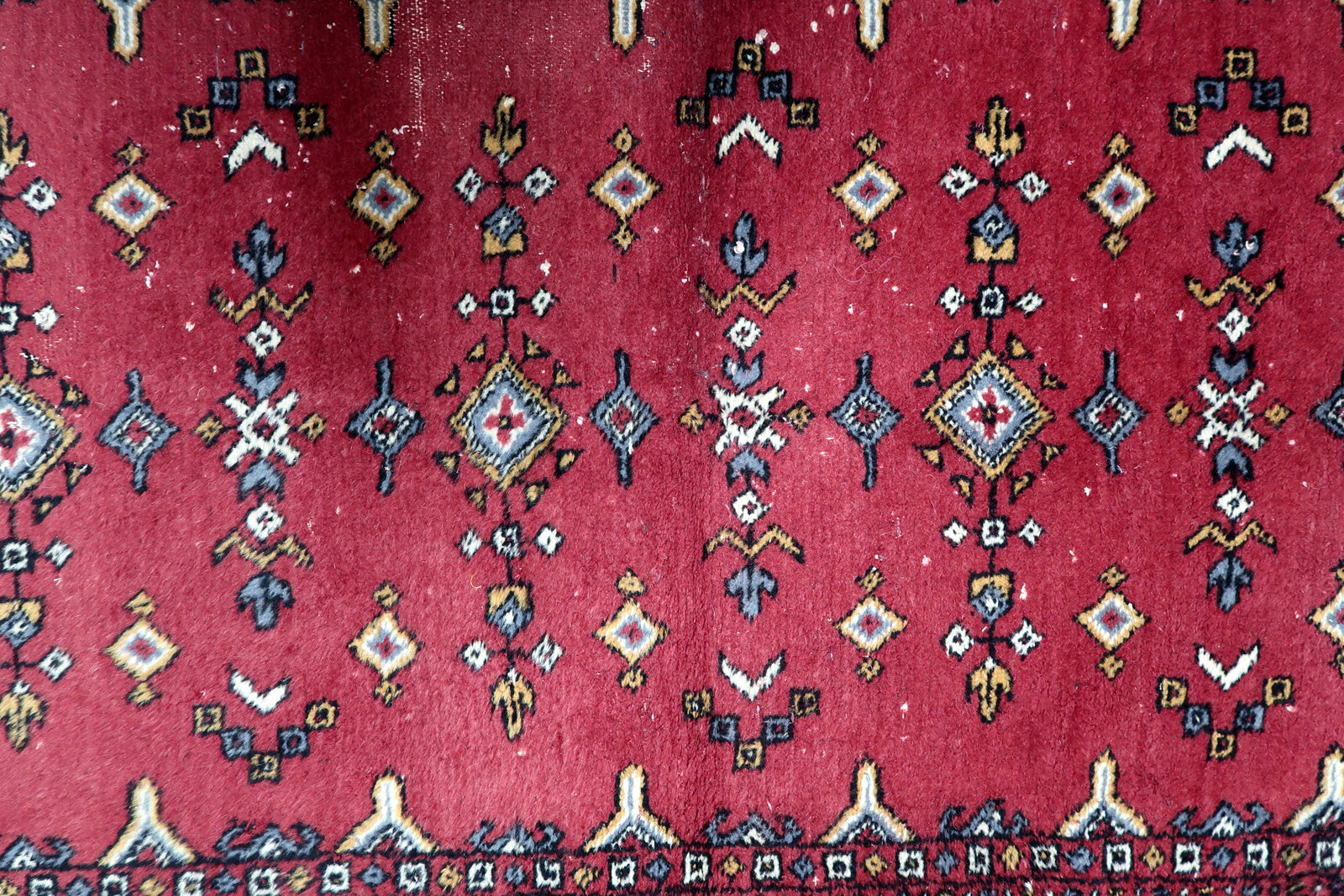 Rich red, deep blue, ivory and gold vintage Uzbek rug with symmetrical diamond medallions and arrow motifs