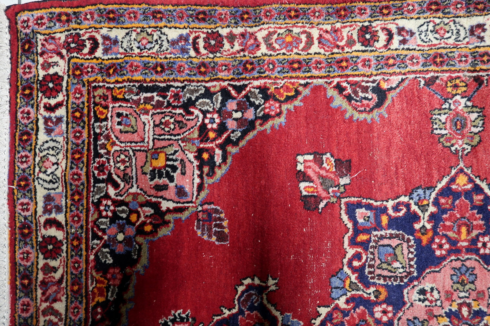 Warm red, navy, pink, ivory and green antique Persian rug with symmetrical medallion and curvilinear floral motifs