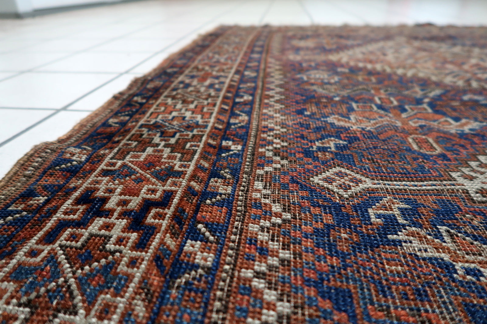  3 foot 6 by 4 foot 8 antique Persian rug ideal for layering, accent placement or decorative textile display