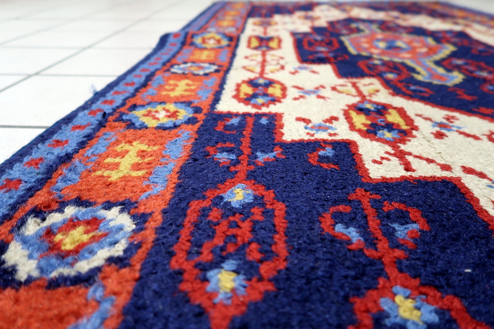 View of the fringed ends adding classic decorative touch to a vintage Savonnerie style floor covering