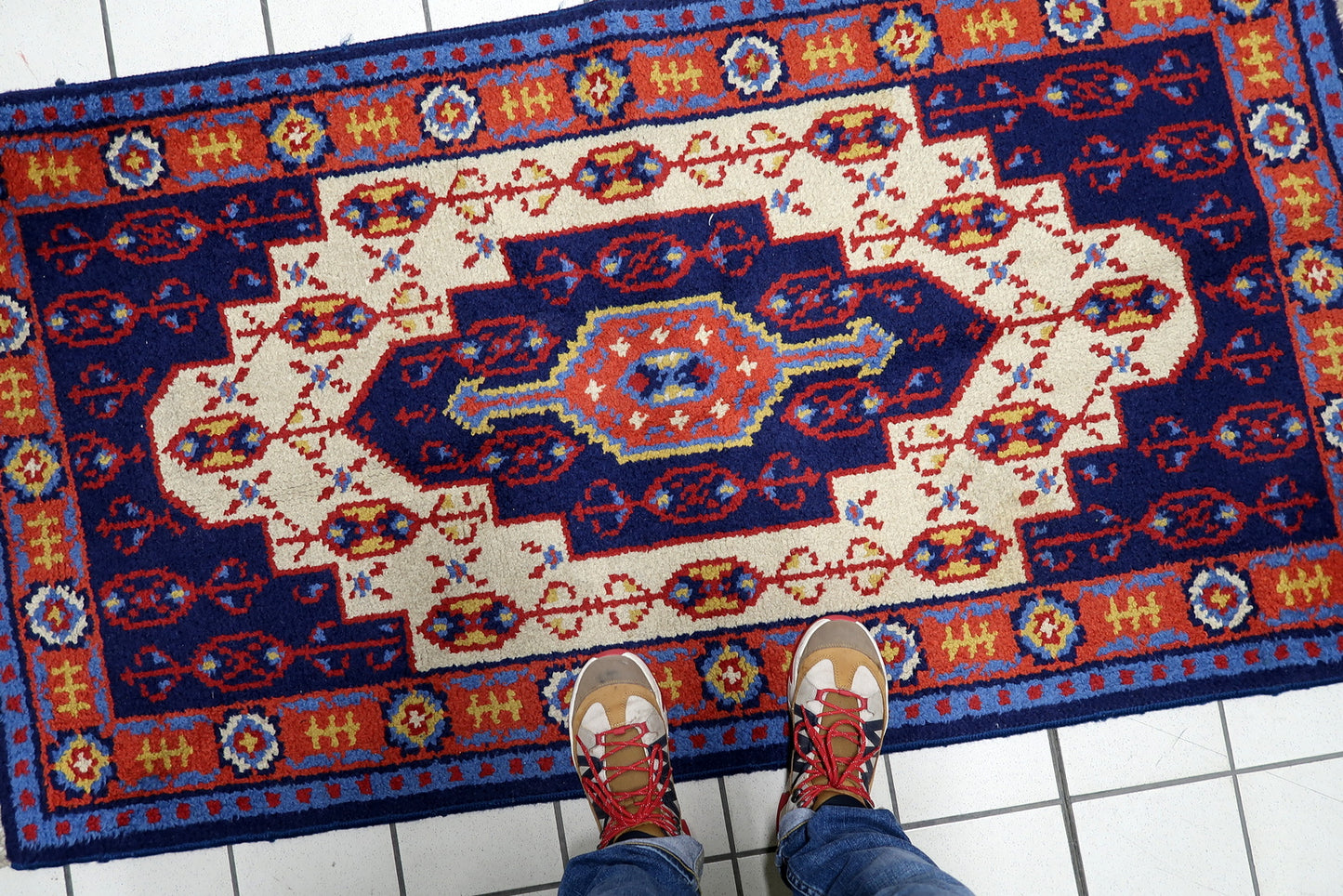 Full view of a machine-woven Savonnerie rug featuring crisp borders and classic fringed ends in good vintage condition
