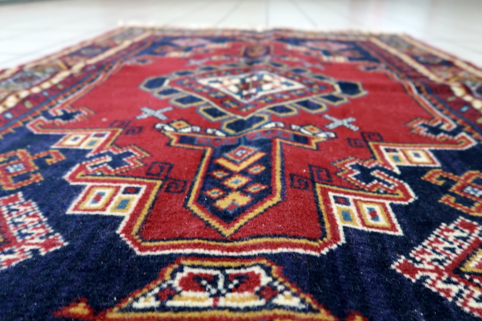 Soft wool pile texture of a 1950s European rug with vibrant colors and good vintage condition
