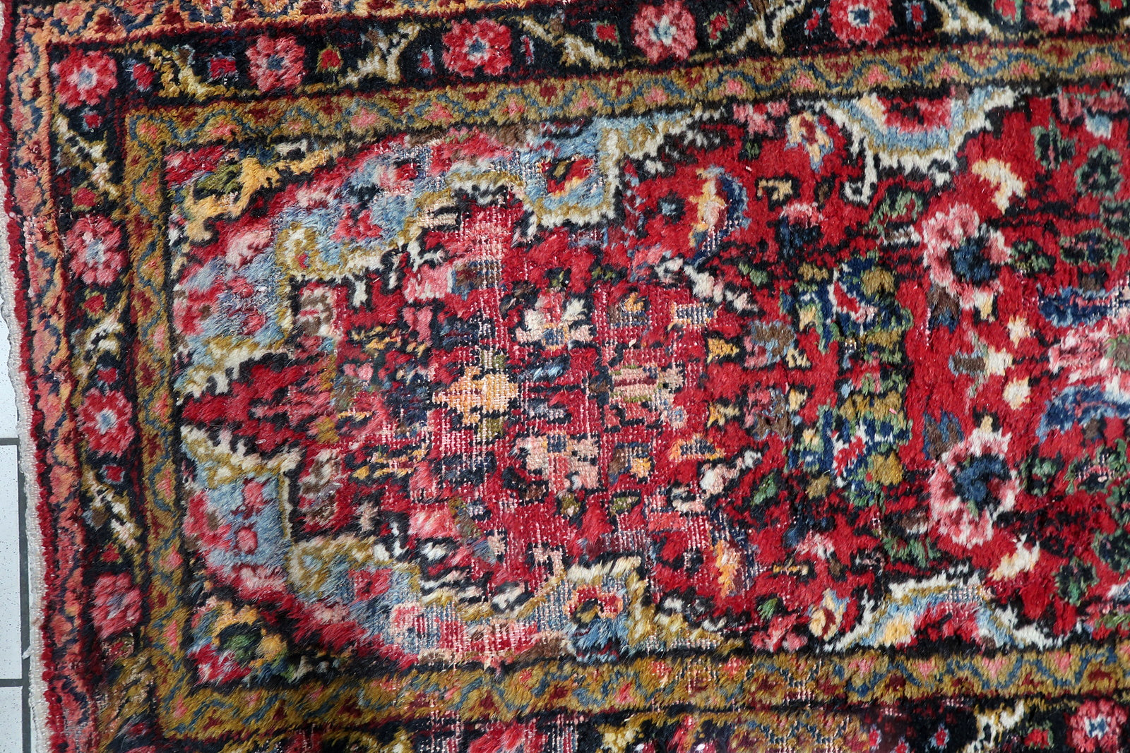 Full view of a narrow vintage hallway runner featuring classic borders that guide the eye along its long elegant shape