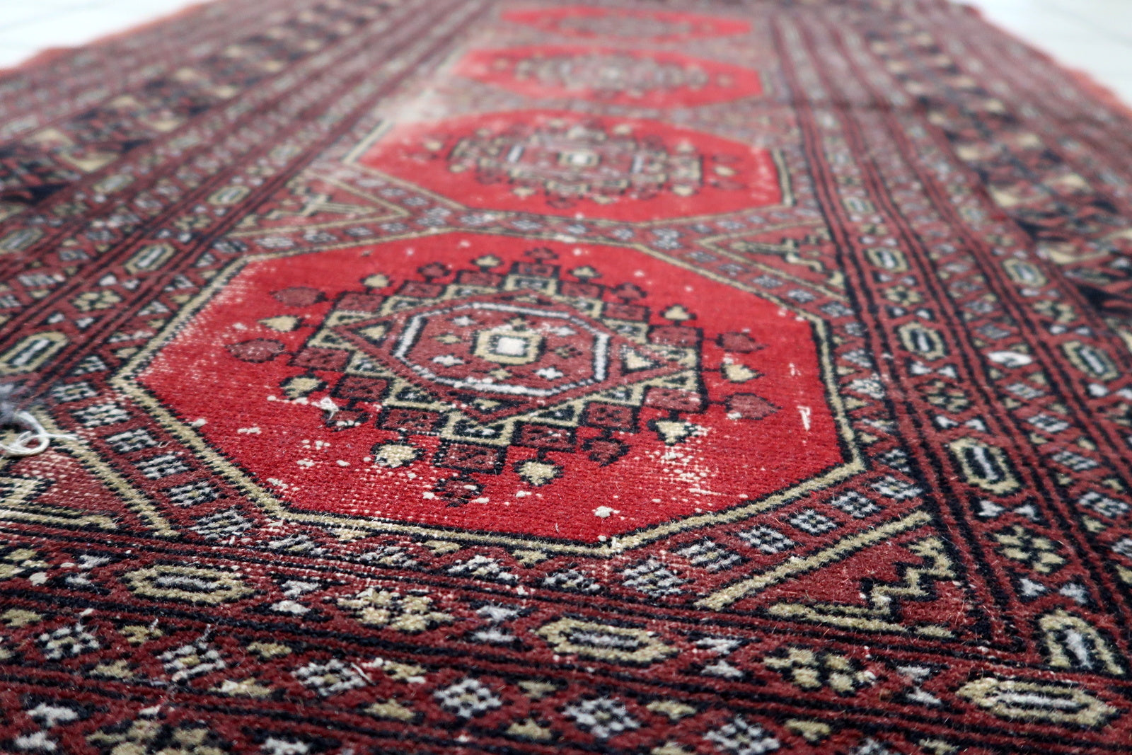 View of the compact size and balanced palette of an antique Bukhara piece ideal for entryways or small spaces
