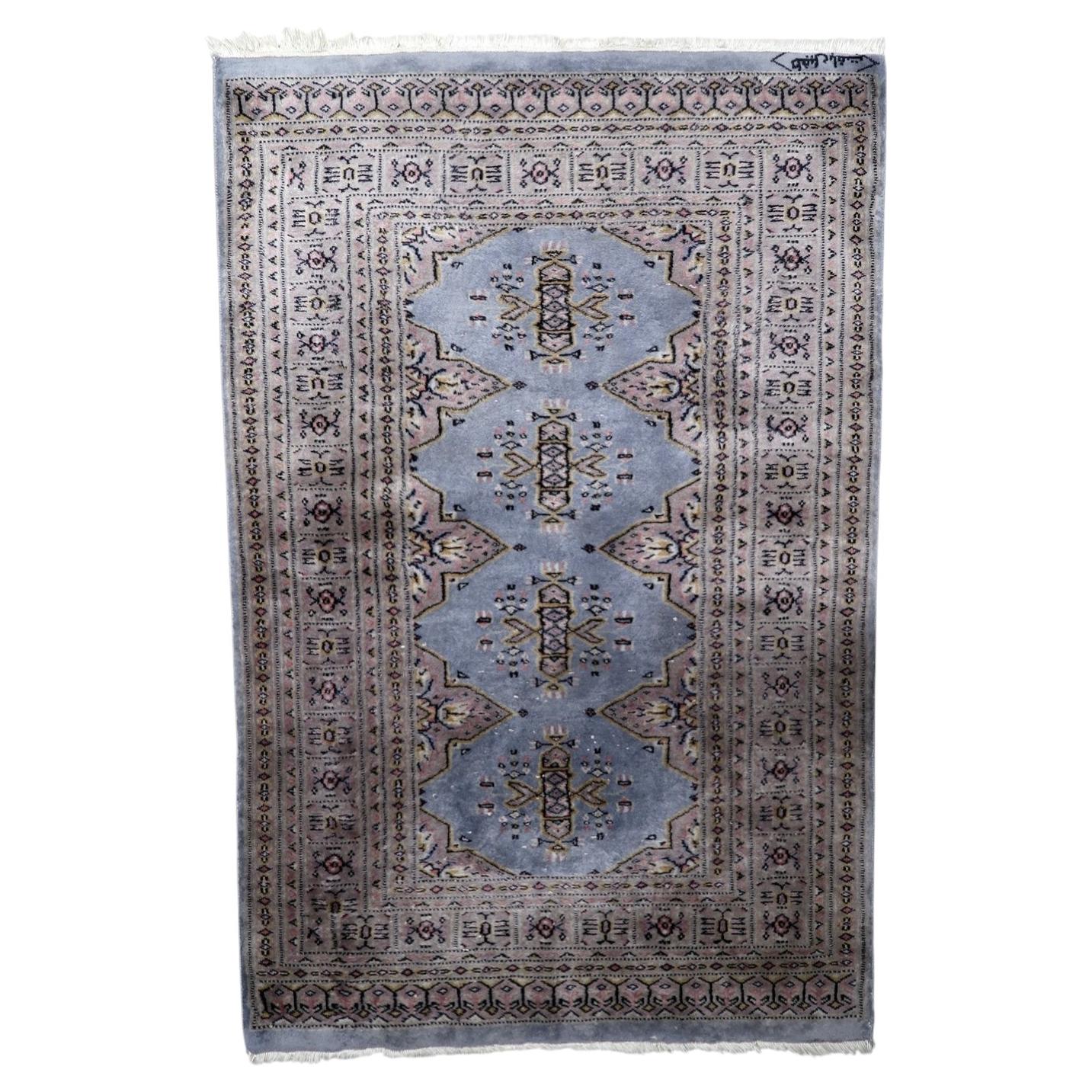 Vintage Uzbek Bukhara rug 1950s wool muted red blue ivory guls