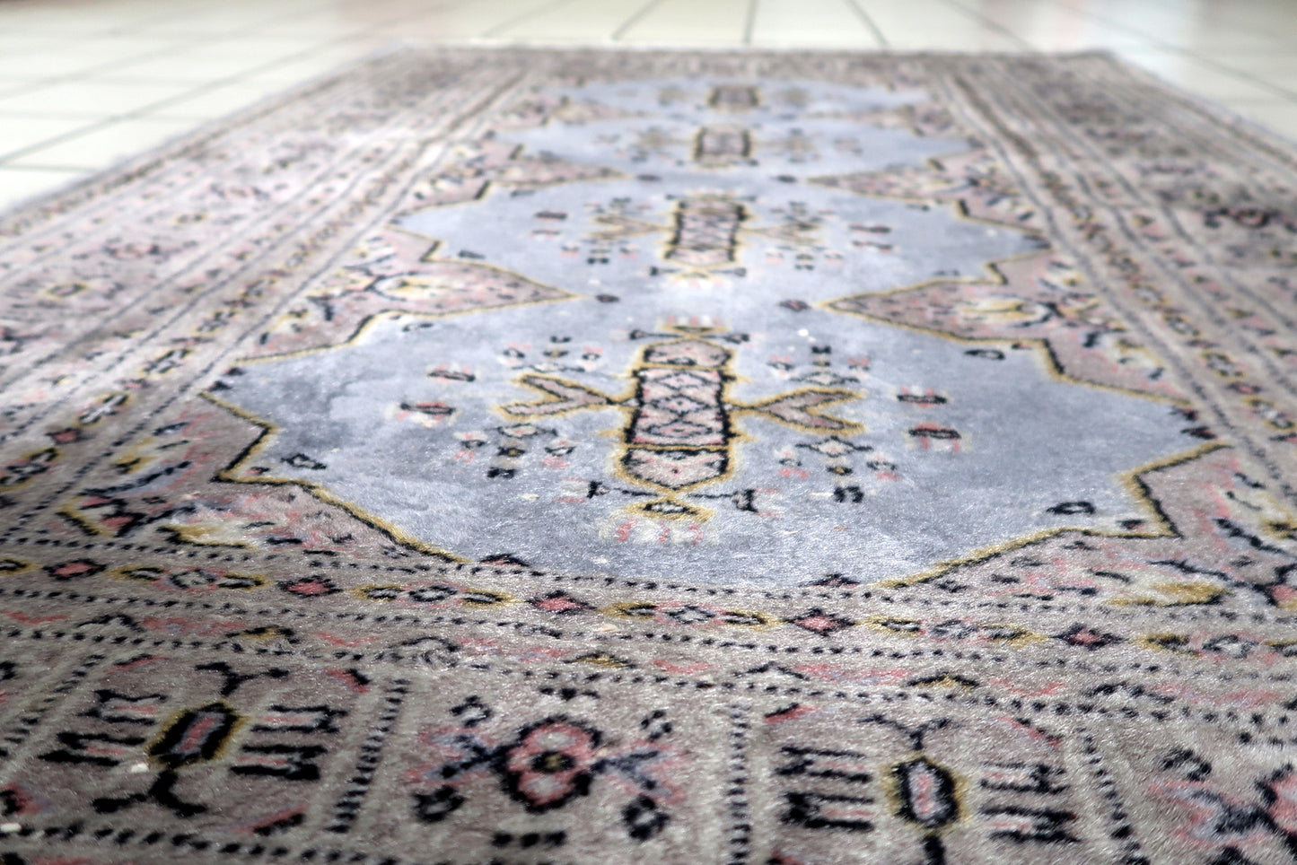 View of the compact size of a vintage Bukhara piece ideal for entryways or bedside placement