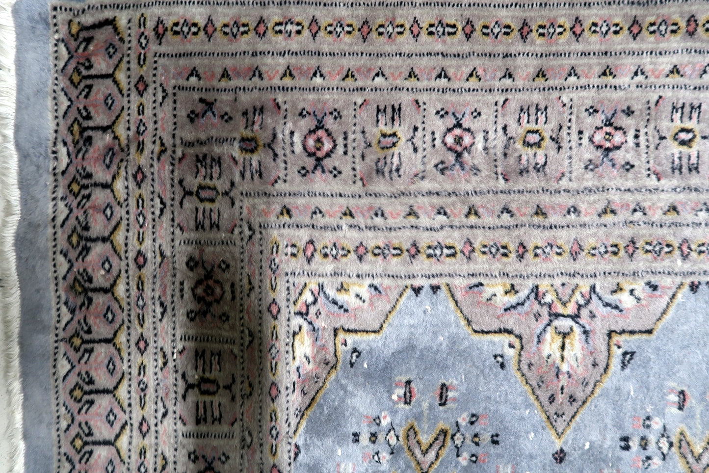 Full view of a Central Asian tribal weaving featuring balanced geometric layout and warm inviting presence