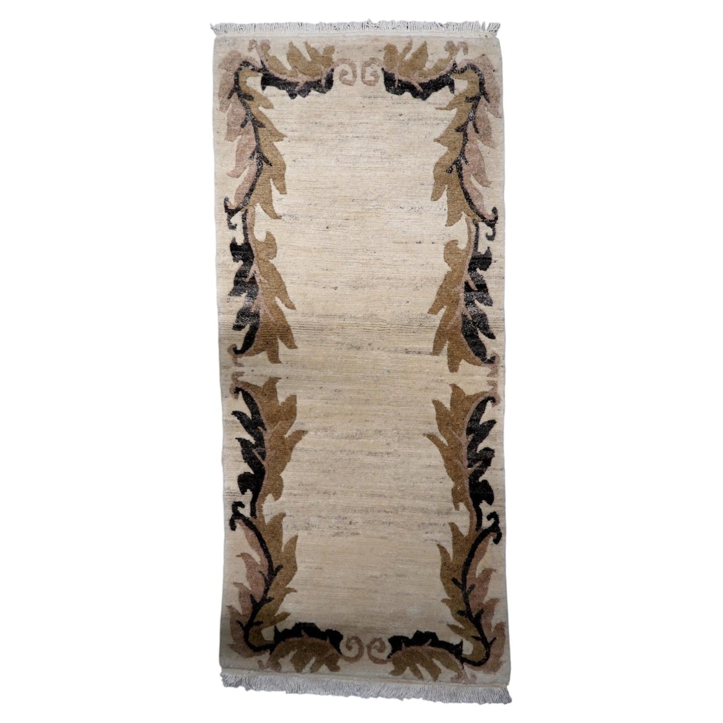 Vintage Tibetan Art Deco Khaden rug from the 1960s, 3 x 6.8 feet, in wool featuring a beige field with brown and charcoal stylized leaf border motifs.

