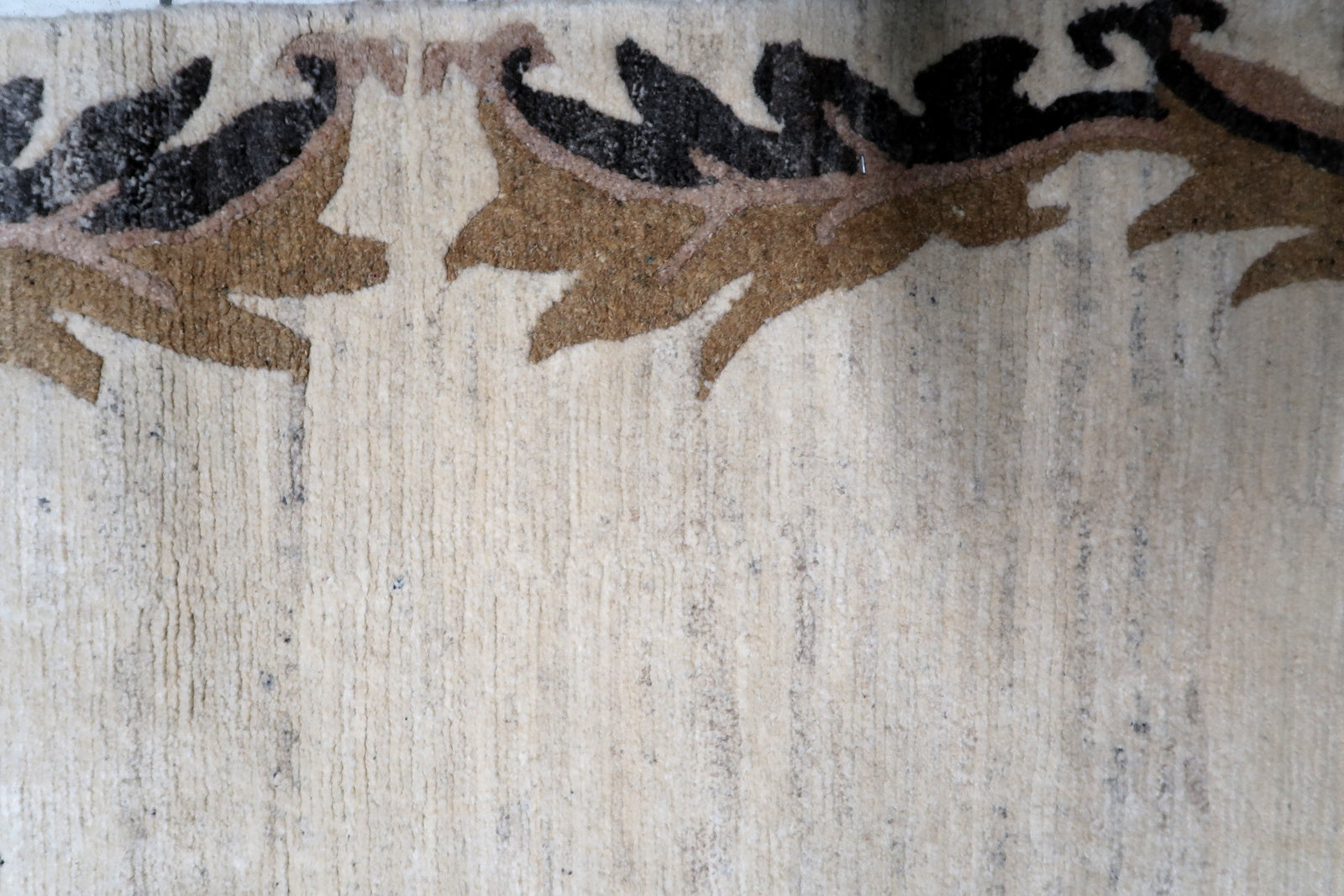 Art Deco inspired Tibetan Khaden rug from the mid-20th century, featuring a balanced composition of a neutral field and expressive border motifs.

