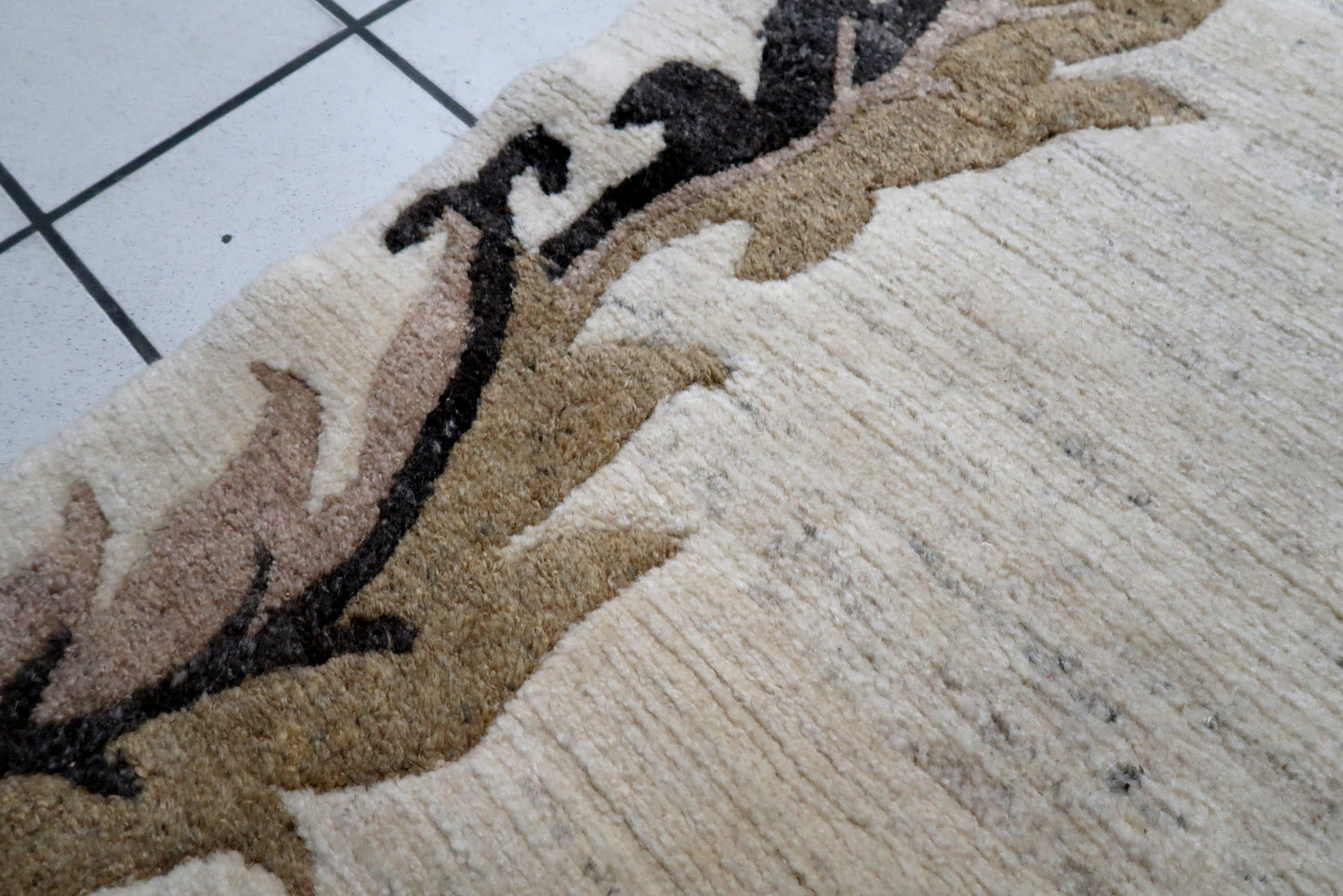 Example of mid-century Tibetan weaving: a Khaden rug with elegant minimalism, combining a light beige ground with warm, earthy border details.

