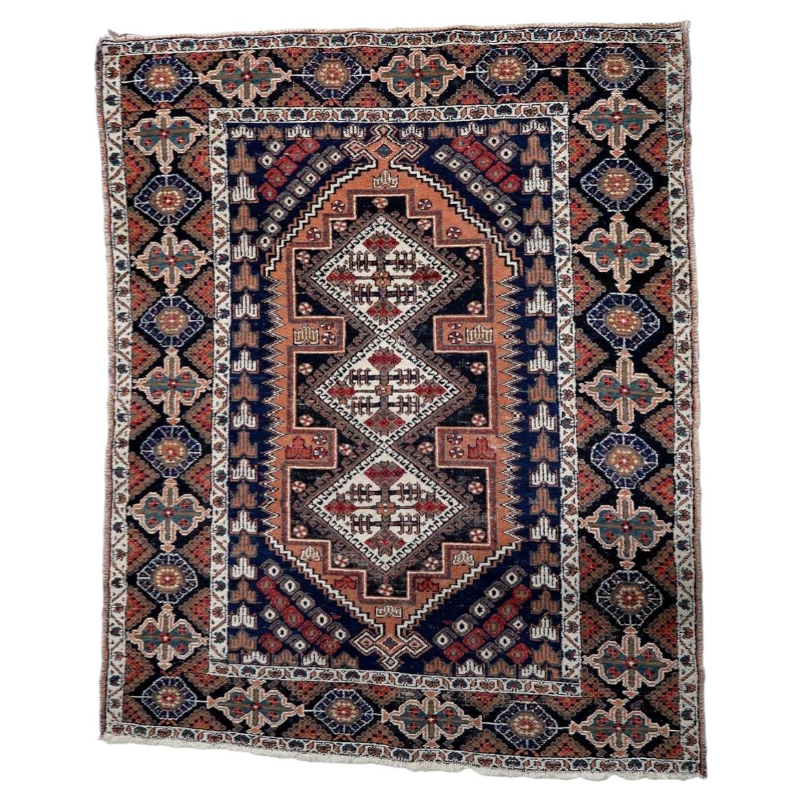 Antique Persian Afshar tribal rug from the 1920s, hand-knotted wool, featuring three diamond medallions in navy, rust, and ivory on a red field.

