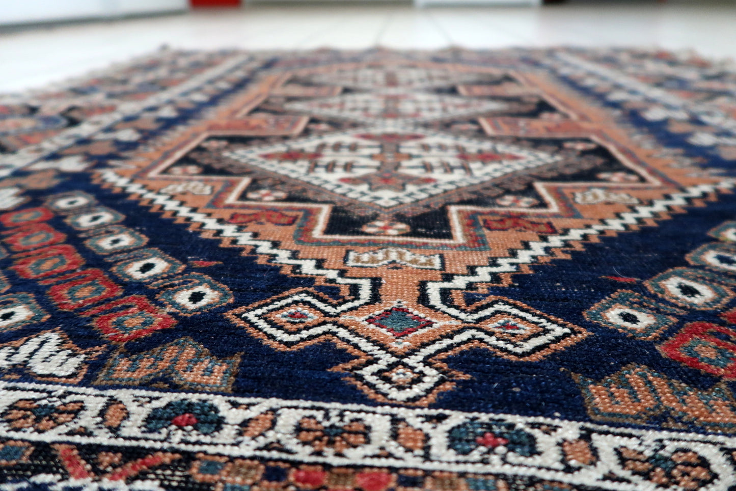 Example of early 20th-century Afshar weaving: a bold and harmonious composition with central medallions and repeating border designs.

