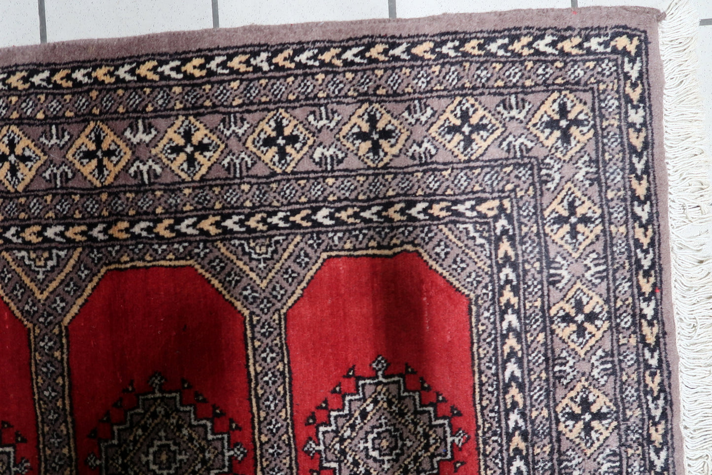 Handmade 1960s Bukhara tribal rug, 3 x 4.6 feet, in red, black, and ivory, displaying the iconic Tekke-influenced gul design.

