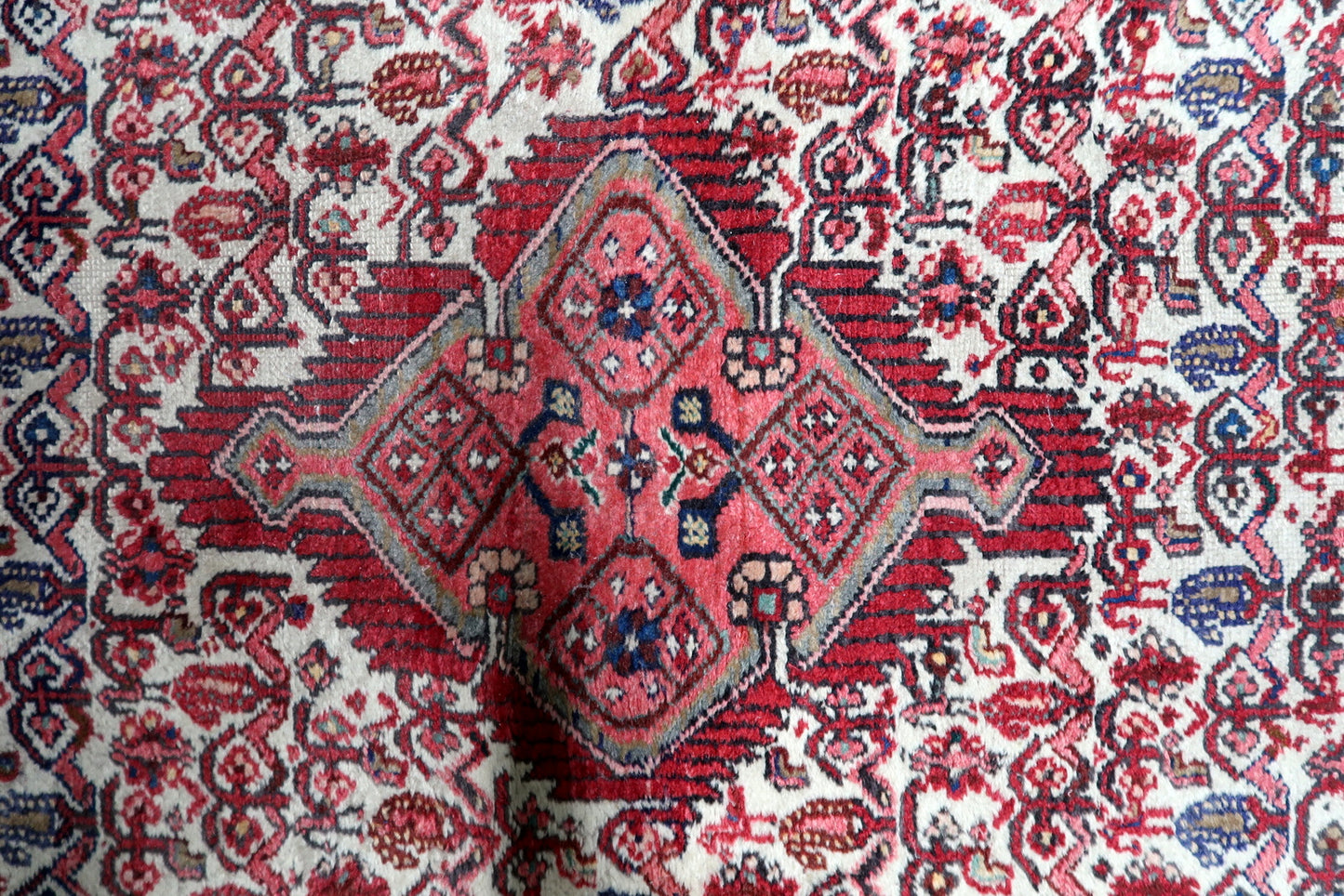 Handmade village rug from Hamadan Persia circa 1920s with rich red and blue color palette

