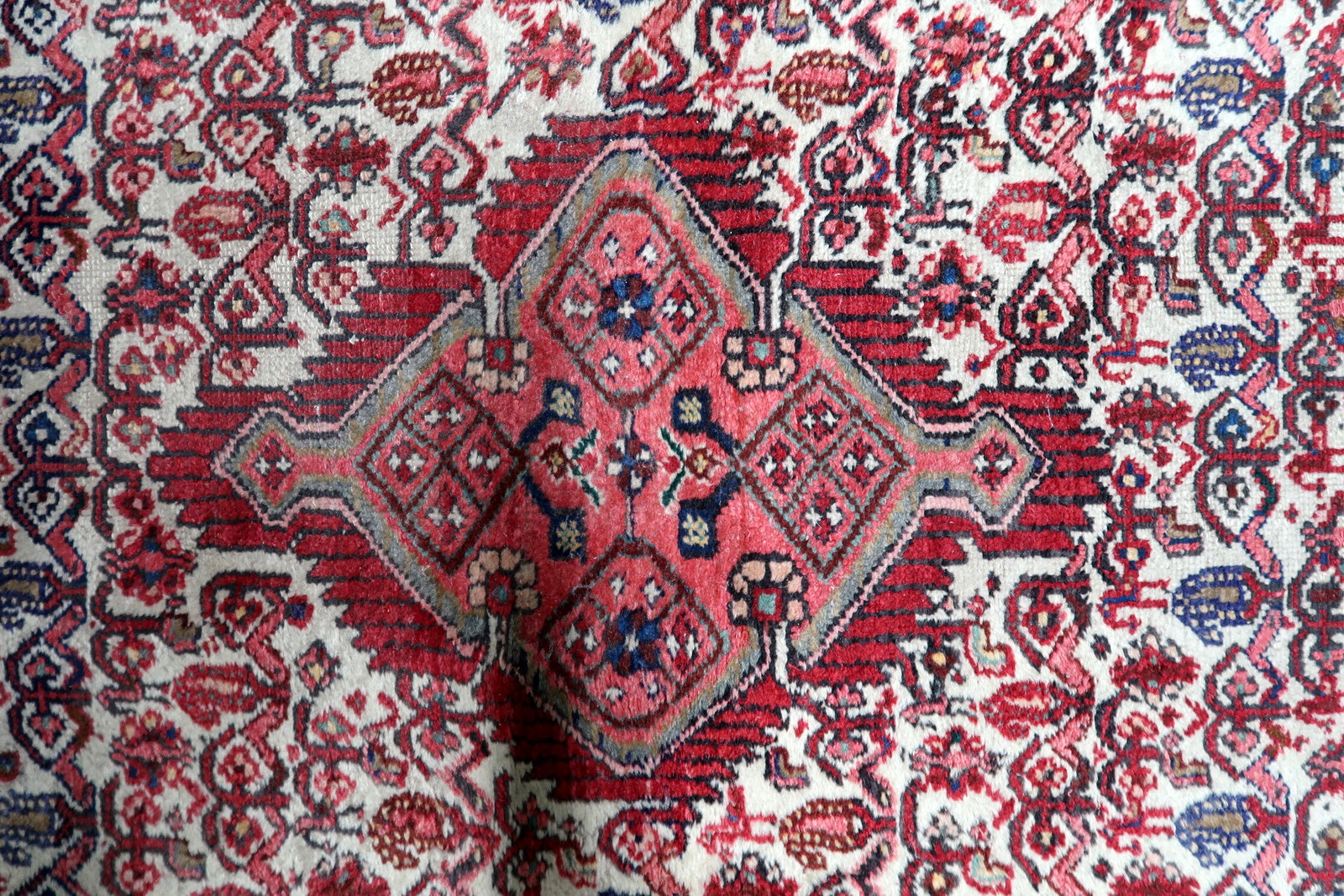 Handmade village rug from Hamadan Persia circa 1920s with rich red and blue color palette

