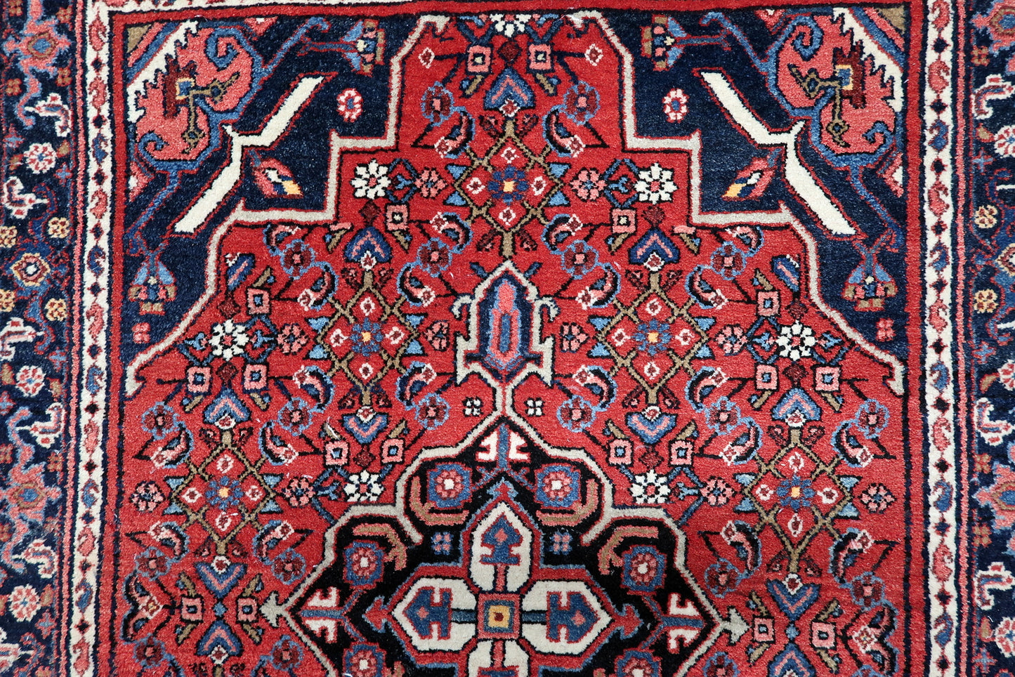 Close-up of vintage Hamadan rug from 1940s showing intricate geometric and floral patterns