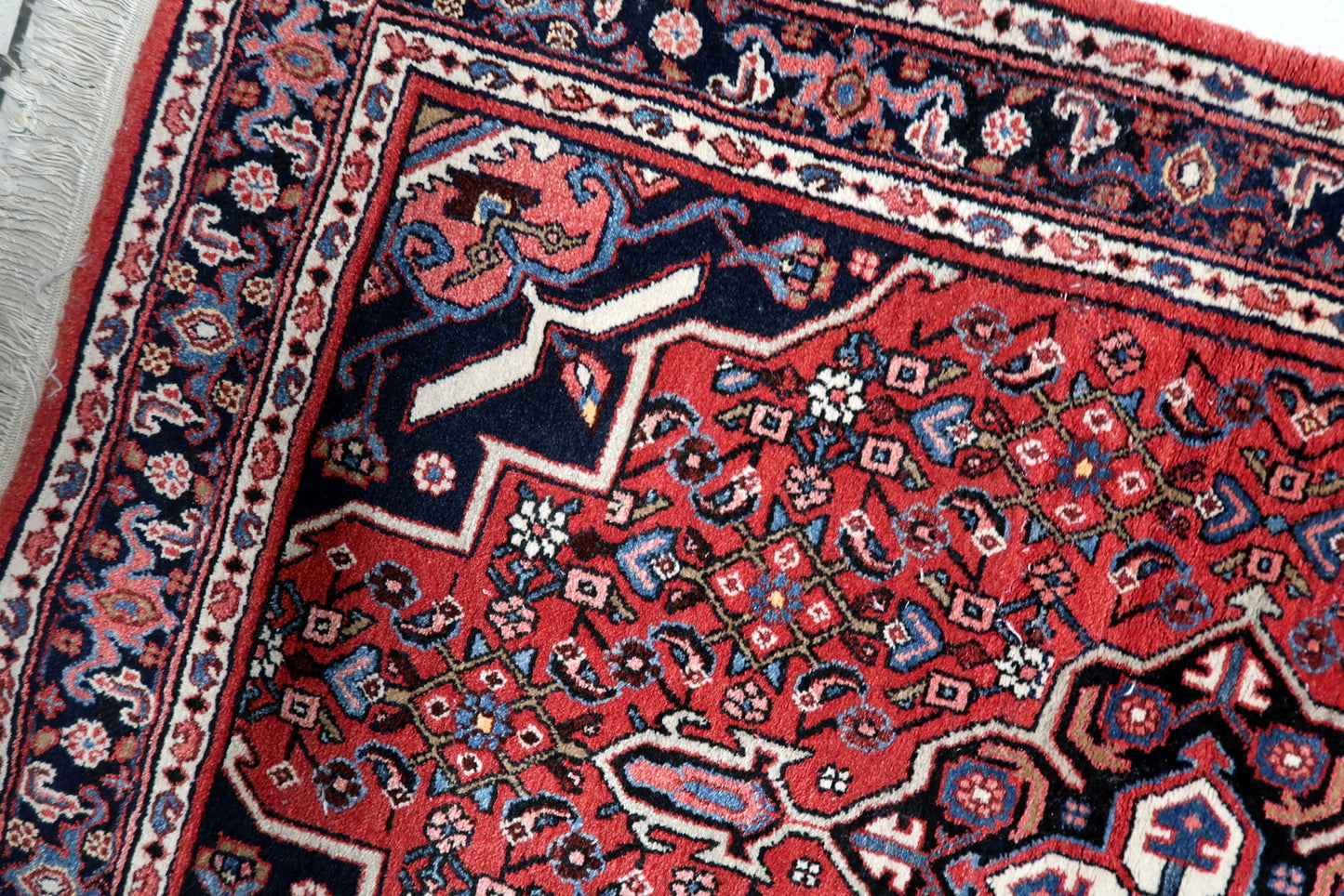 Handmade Hamadan village rug Persia circa 1940s with red navy ivory and black color palette

