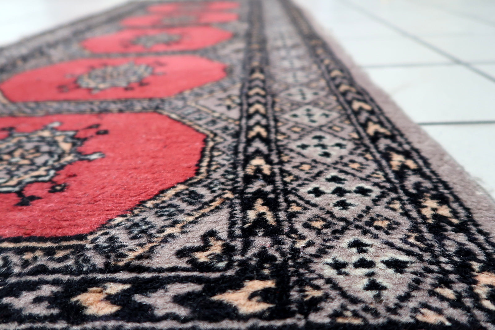 Detail of traditional Tekke motifs and rhythmic patterns on 1960s Uzbek tribal rug
