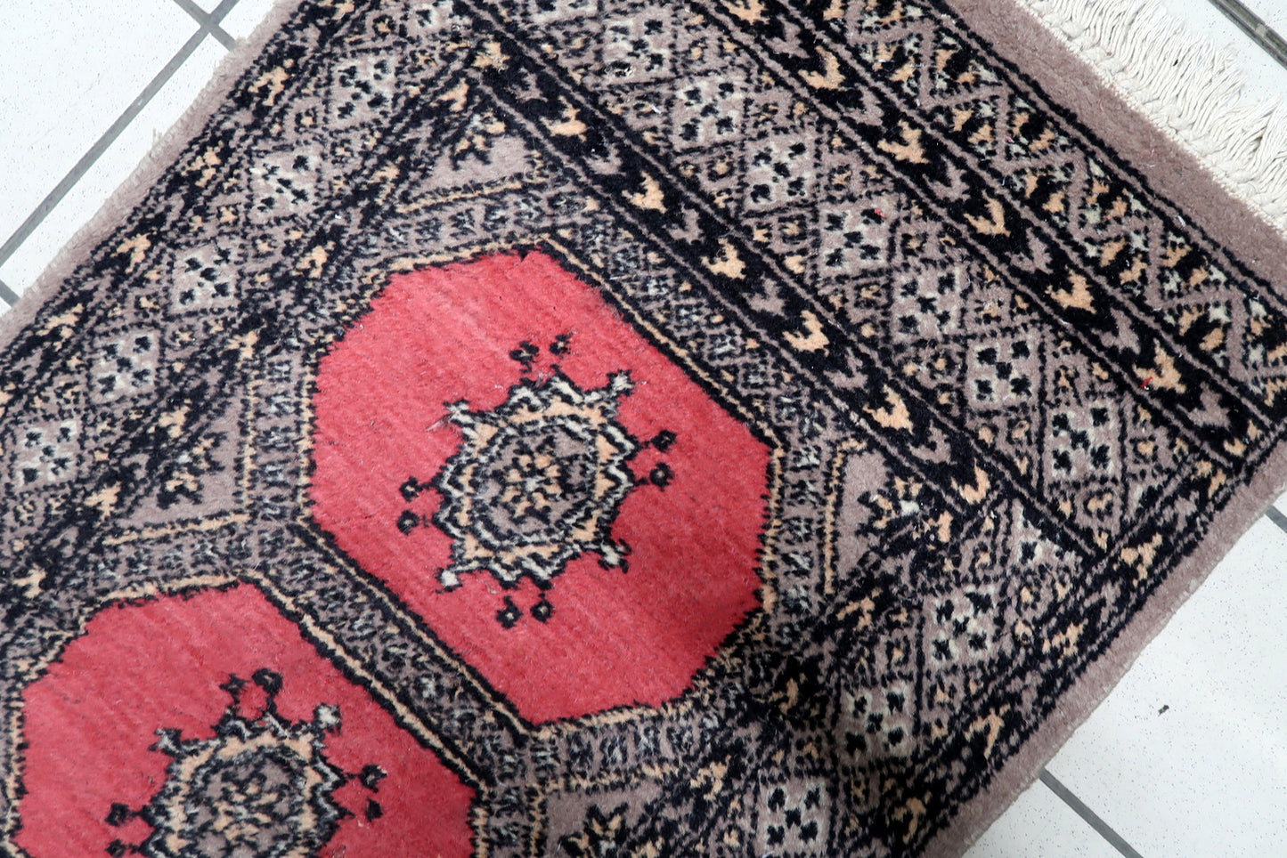 Close-up of 1960s Bukhara runner displaying traditional Tekke-influenced gul design

