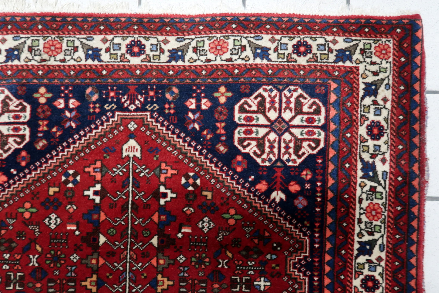 Antique Persian carpet ideal for living room bedroom or entryway in interior setting

