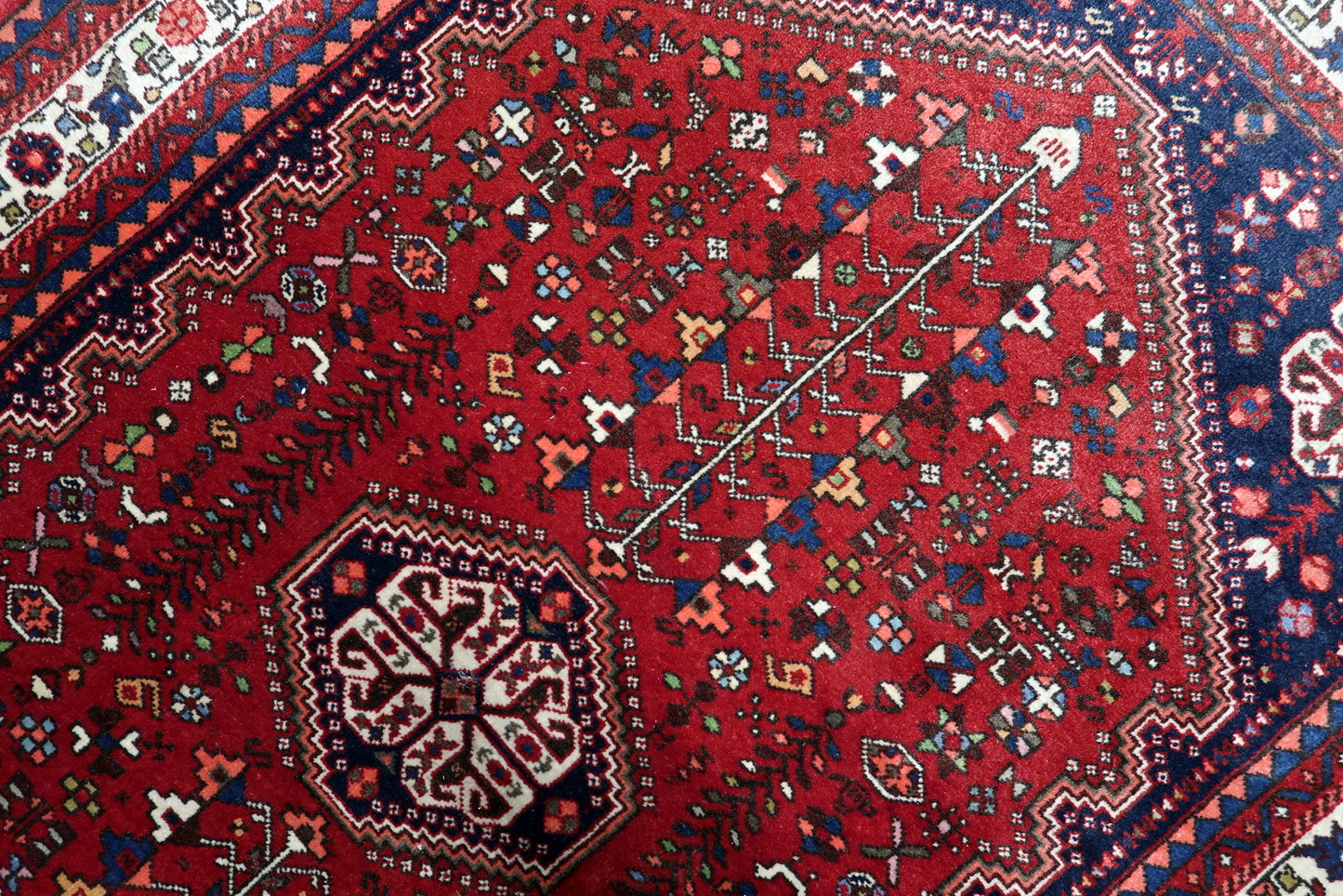 Handmade Qashqai tribal rug Persia circa 1920s with red navy ivory and black color palette


