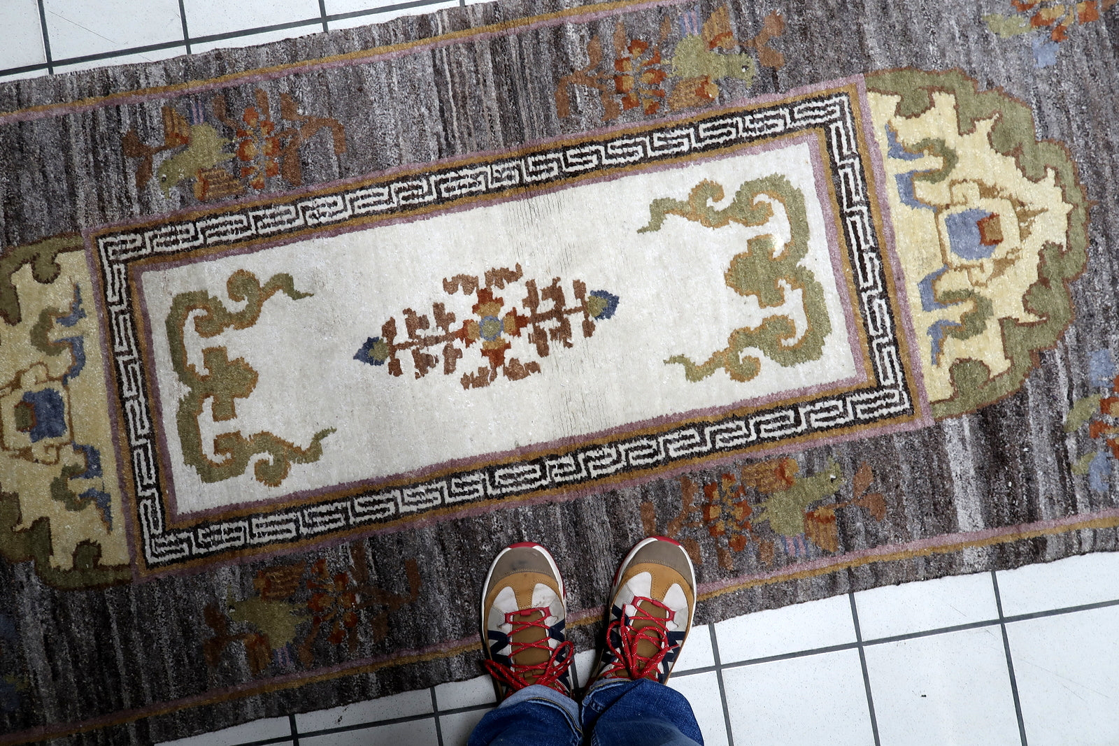 Close crop of flanking pagoda medallions against sophisticated dark field on 1960s rug

