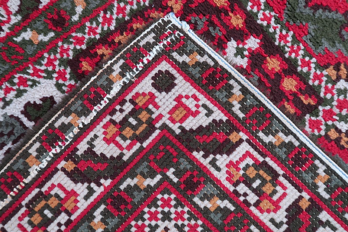 Corner detail showing intact edges and well-preserved fringe on mid-century French rug