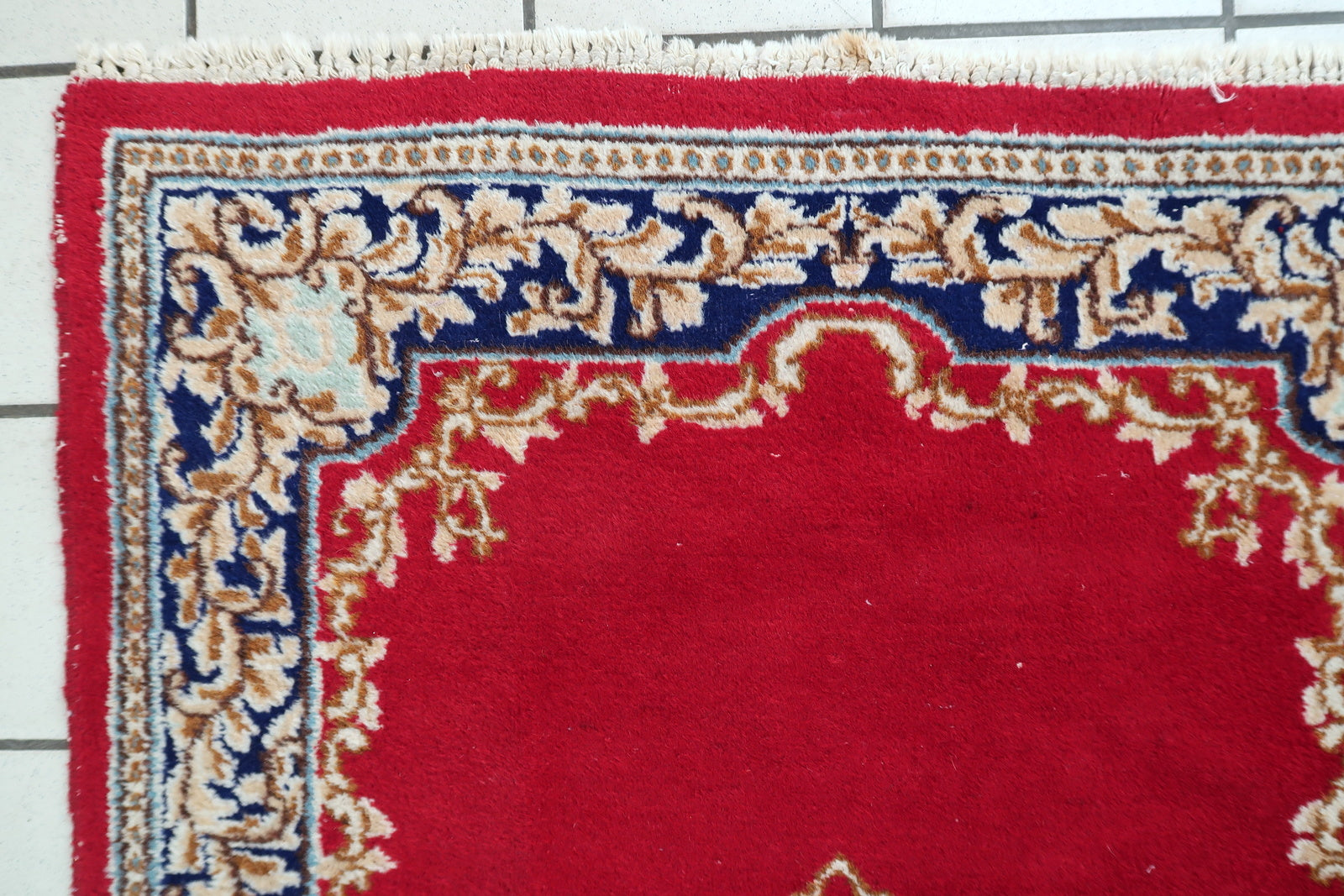 Mid-century Kirman rug from southeast Persia with soft creams rose pinks and deep navy accents on floor

