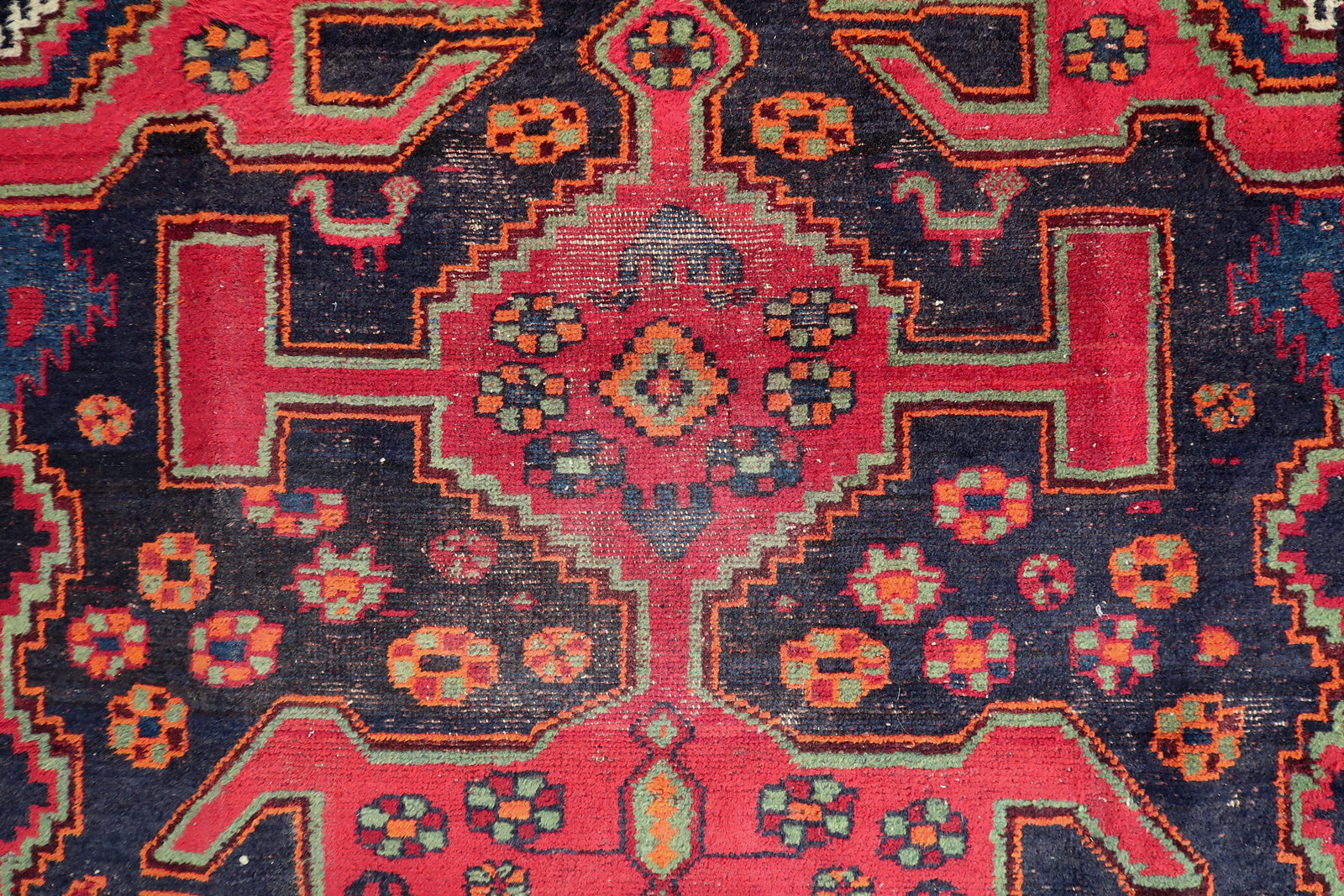 Persian Hamadan rug close-up, showing detailed hand-knotted wool texture