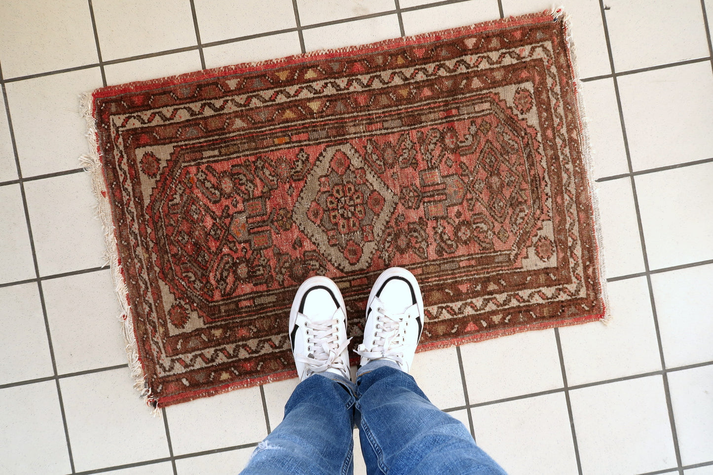 Persian Hamadan rug close-up, highlighting aged patina and distressed pile