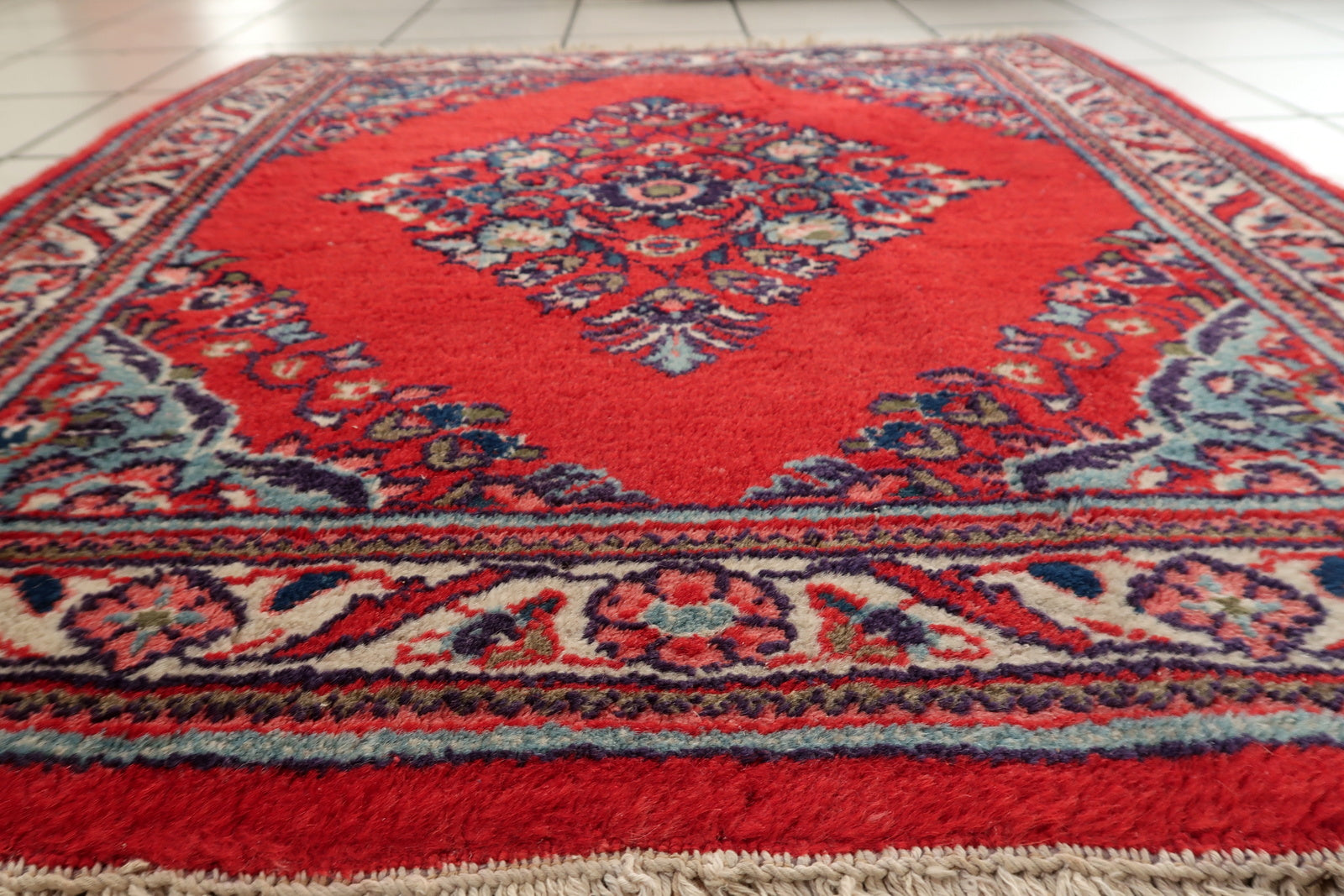 Persian Hamadan rug corner detail, showcasing craftsmanship and aged patina