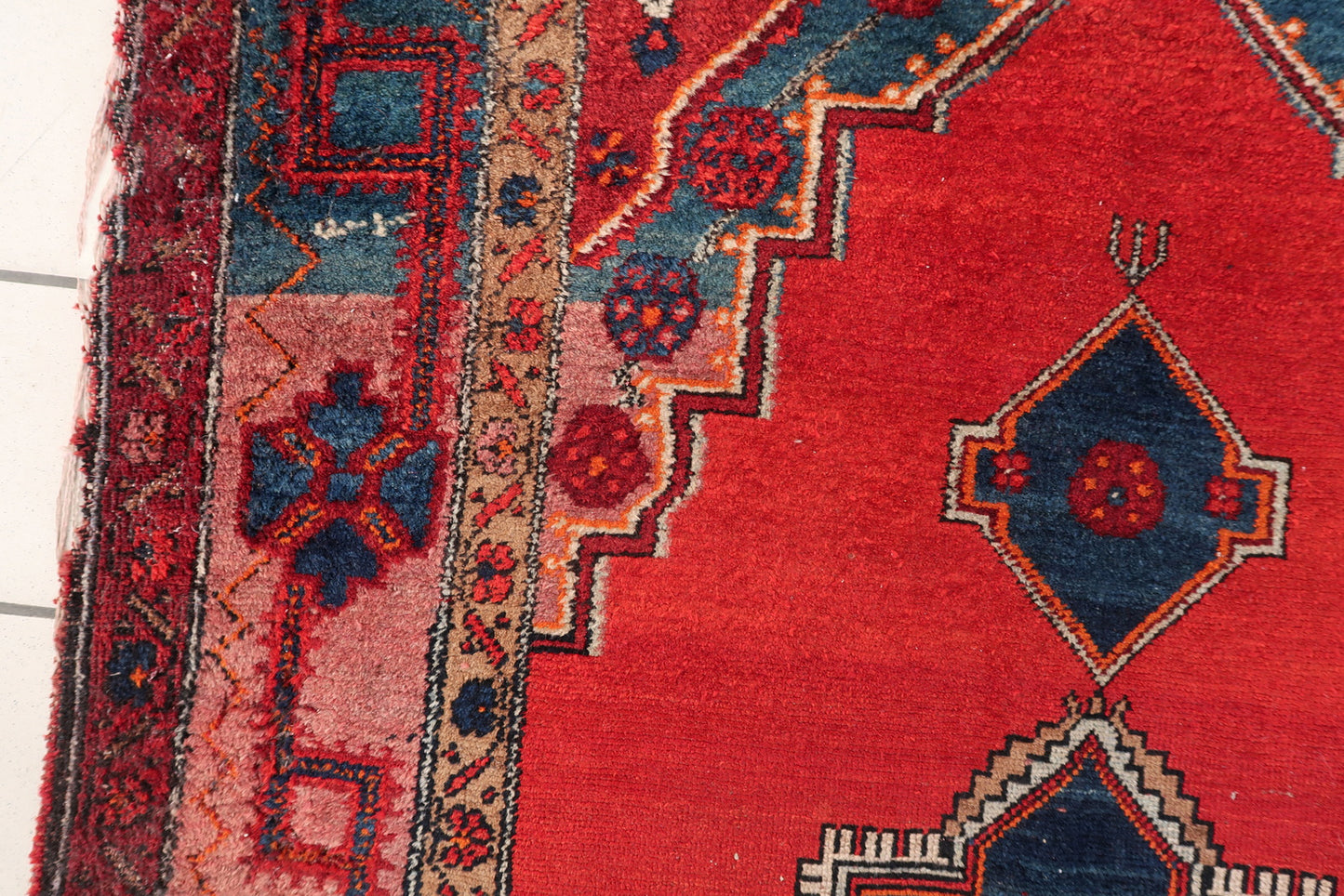 Malayer rug corner detail, showcasing craftsmanship and aged patina