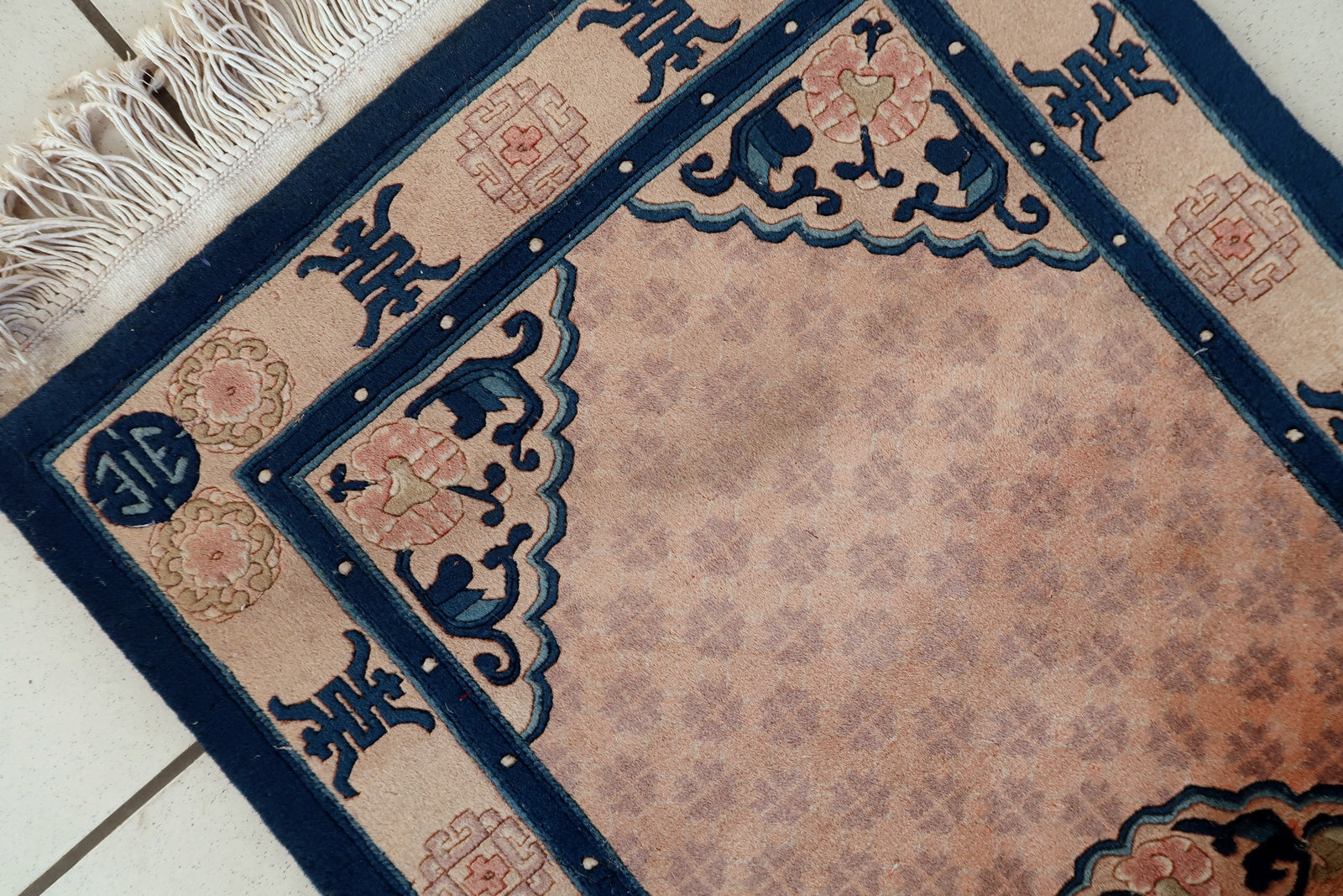 Vintage Chinese rug close-up, showing soft lustrous wool pile and texture