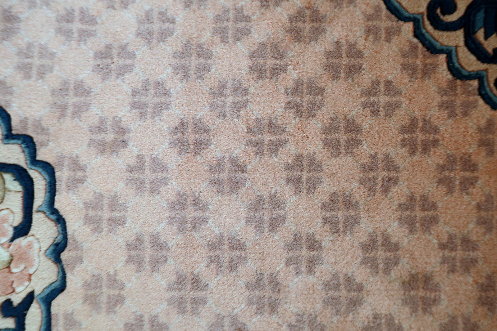 Chinese Art Deco rug corner detail, showcasing craftsmanship and aged patina