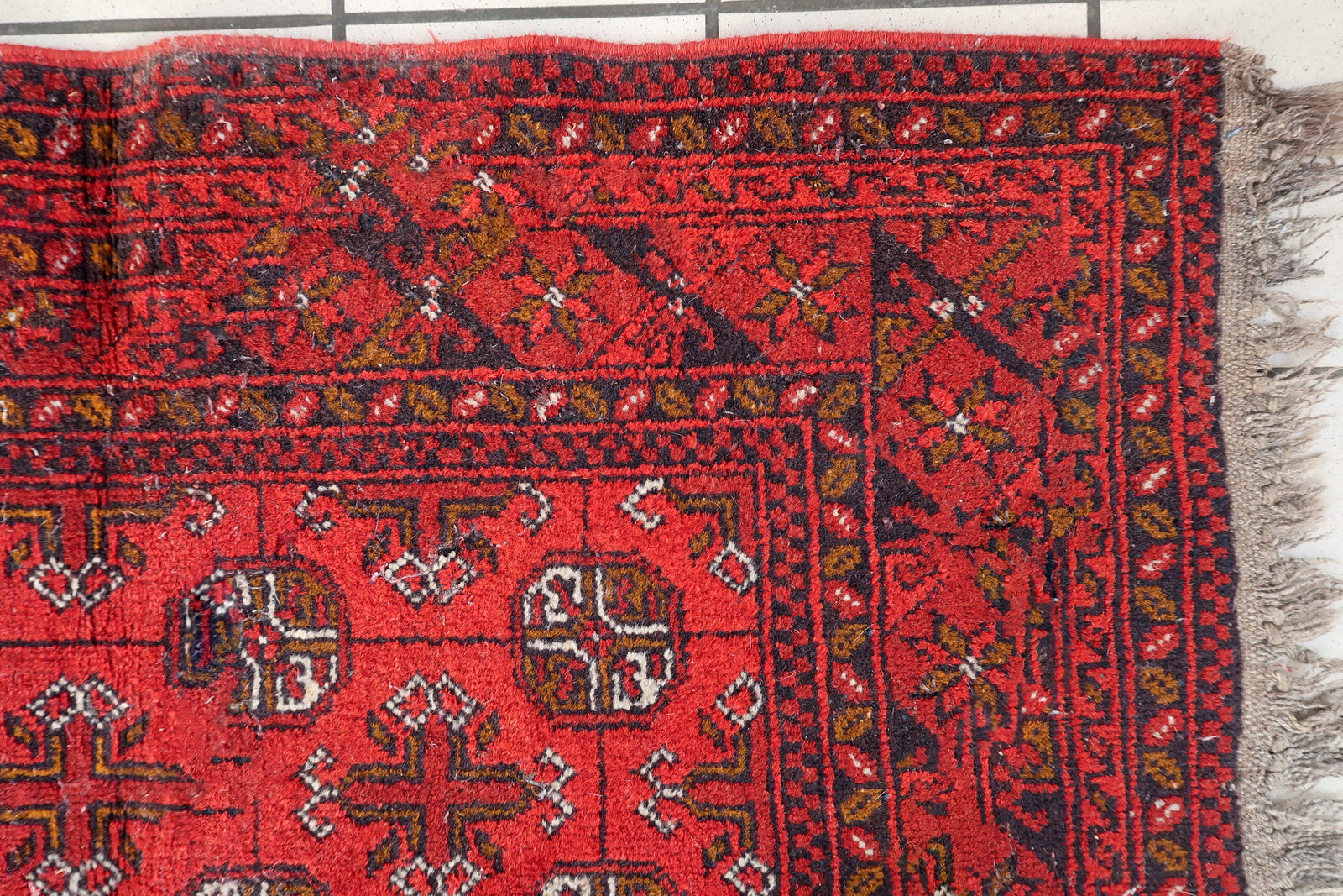 Vintage Ersari tribal rug from Afghanistan, wool carpet with repeating medallions