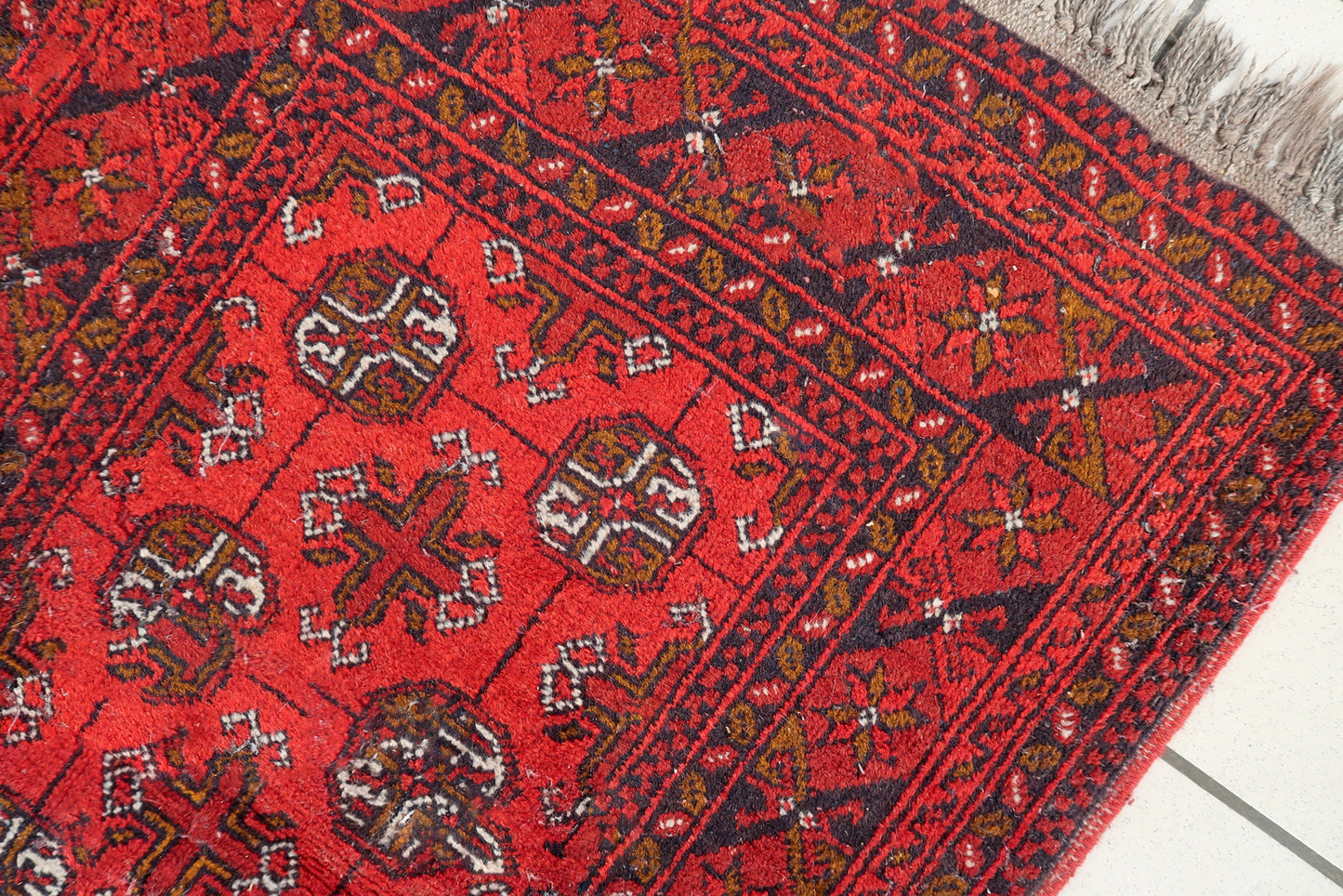 Antique Afghan Ersari rug full view, geometric tribal design with rich red tones