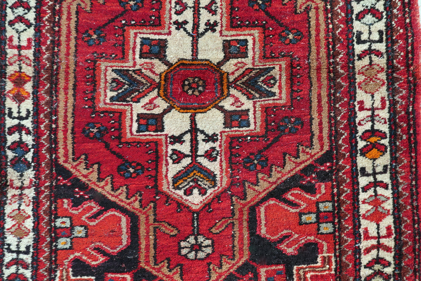 Persian Hamadan rug detail, bold geometric motifs in rich red and blue tones