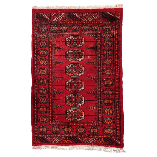 Vintage 1940s Uzbek Bukhara rug, hand-knotted wool with repeating gul motifs
