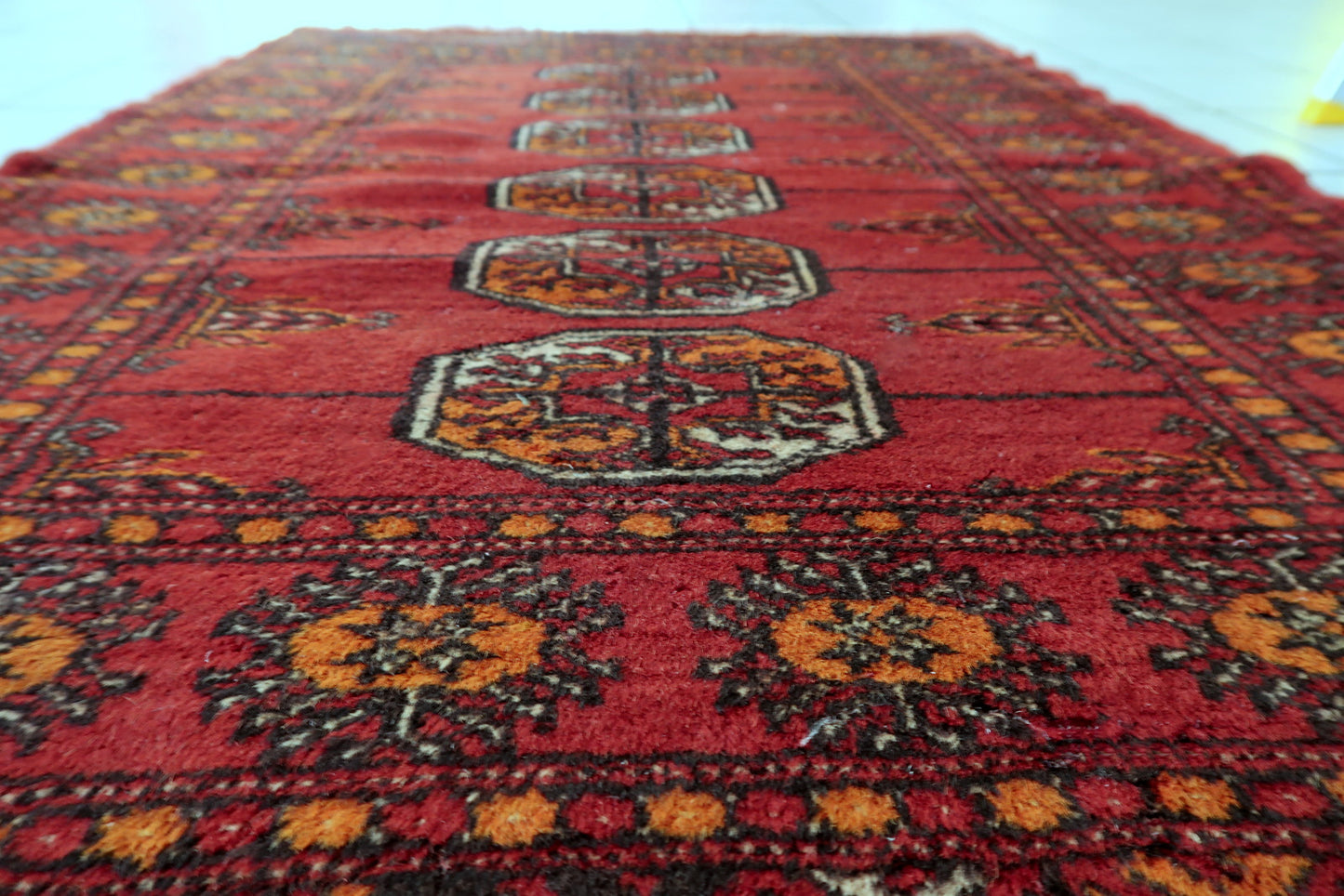 Bukhara rug corner detail, showcasing craftsmanship and aged patina