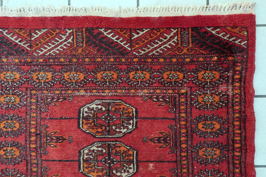 Uzbek Bukhara wool rug full view, tribal geometric design with deep red tones