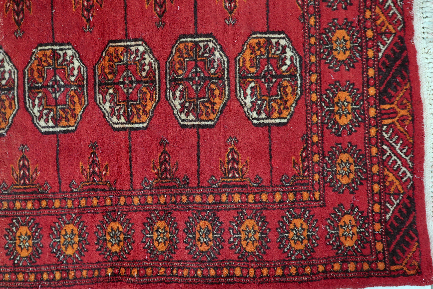 Uzbek Bukhara rug detail, geometric gul motifs in symmetrical rows