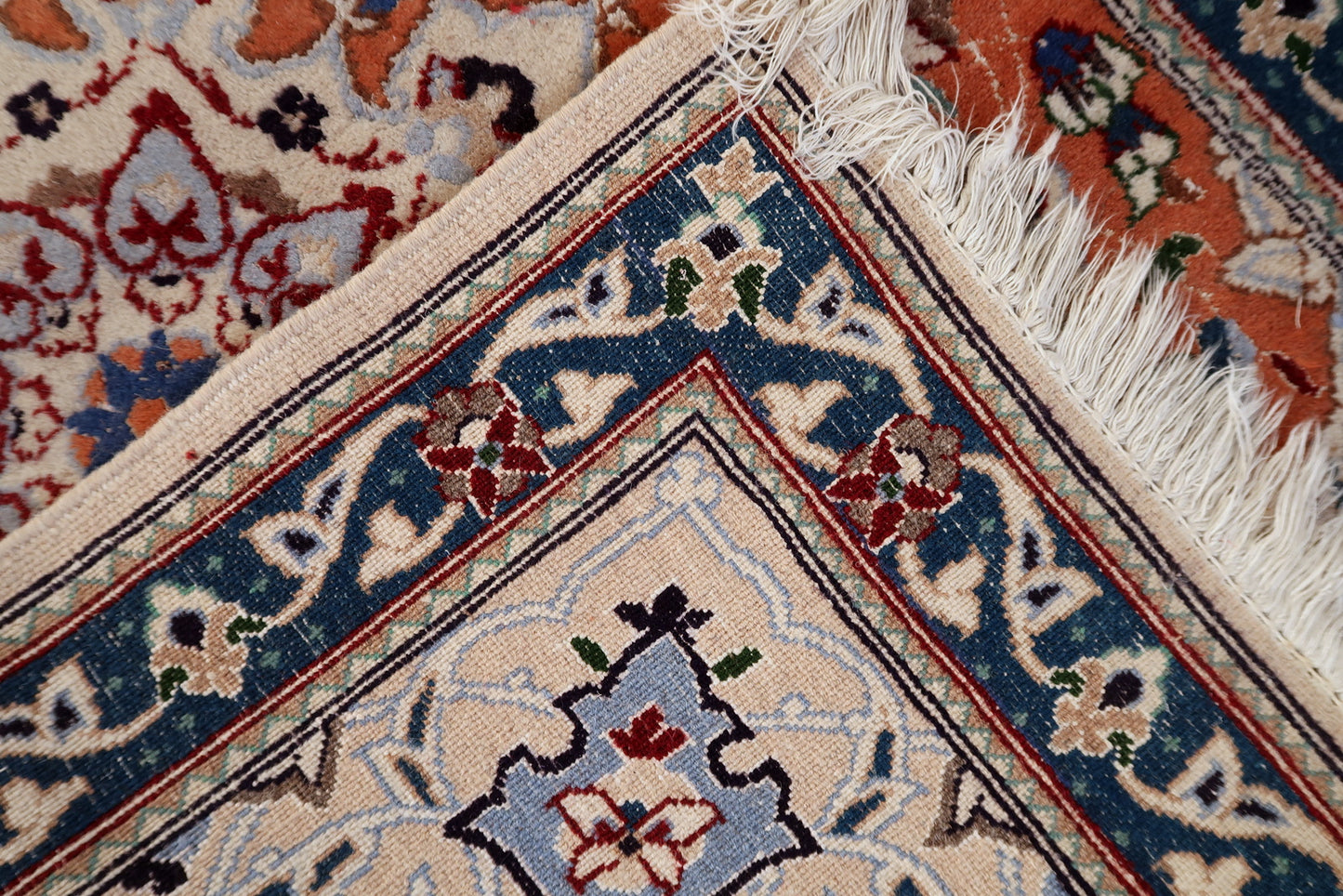 Persian Tabriz rug corner detail, showcasing craftsmanship and aged patina