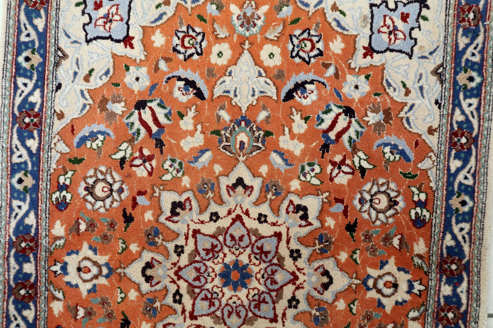Tabriz rug close-up, showing fine knotting and shimmering silk details
