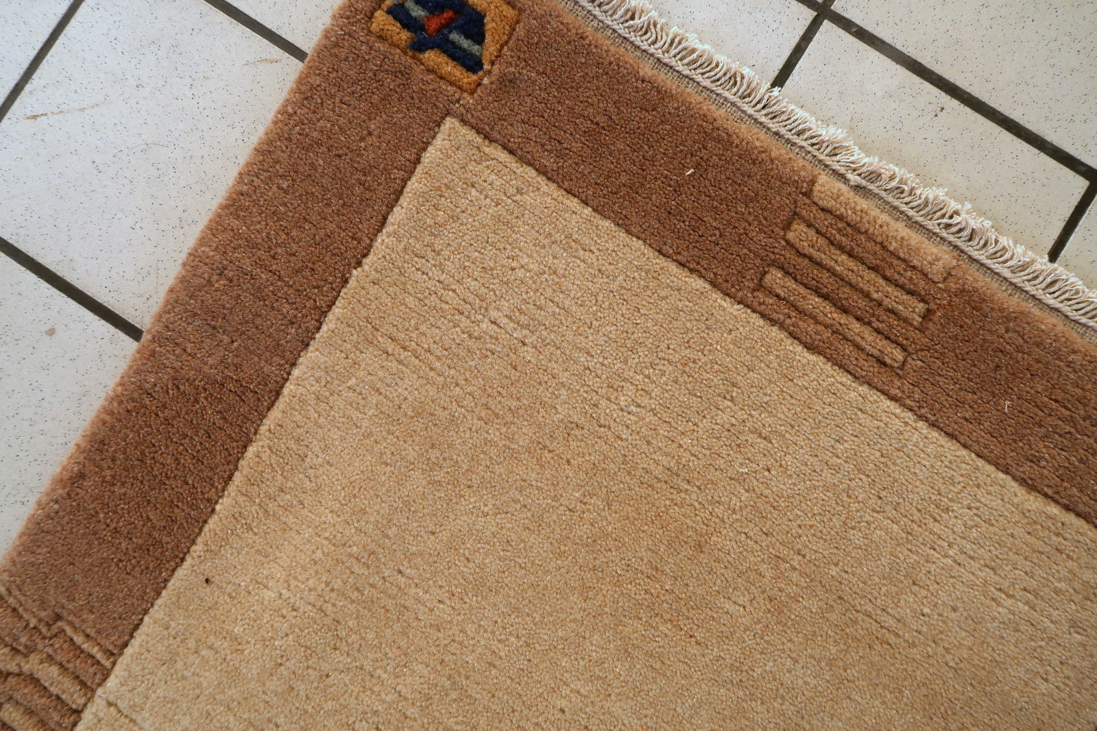 Vintage Tibetan rug close-up, showing soft wool pile and hand-knotted texture