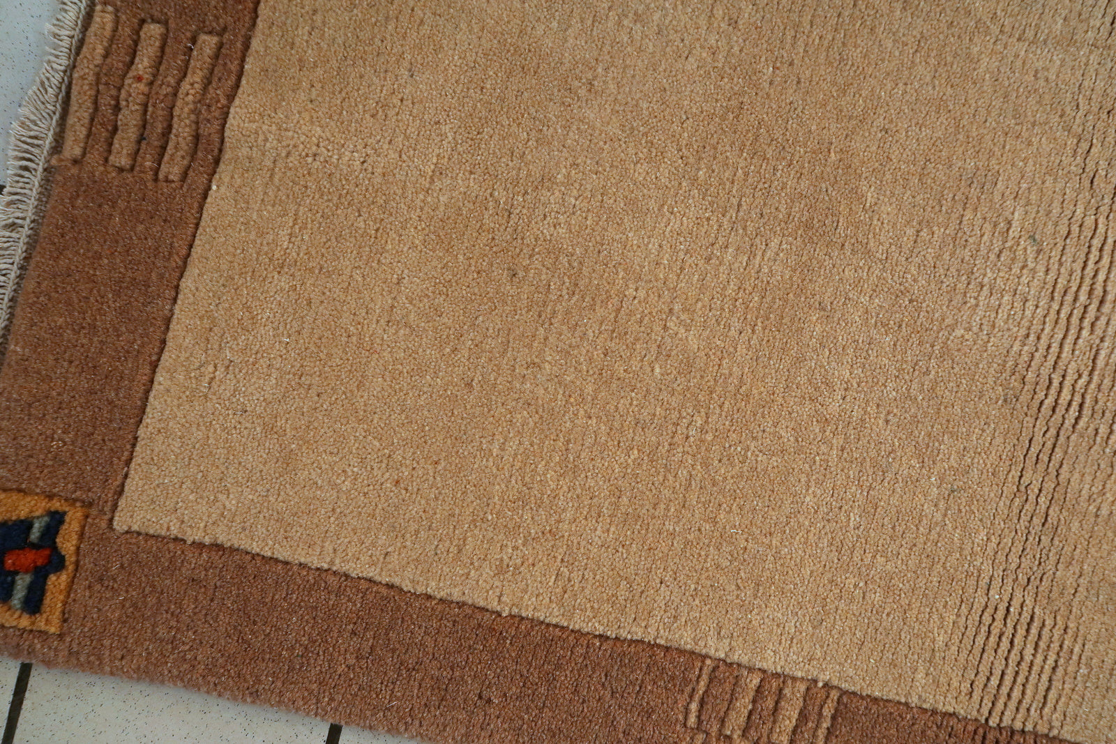 Tibetan Khaden rug corner detail, showcasing craftsmanship and aged patina